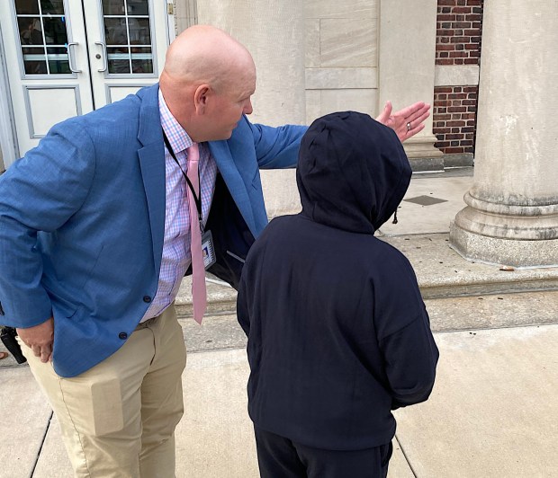 Beverly Hill Middle School Principal Wayne Remmey directs a new student to class. (PETE BANNAN-DAILY TIMES)