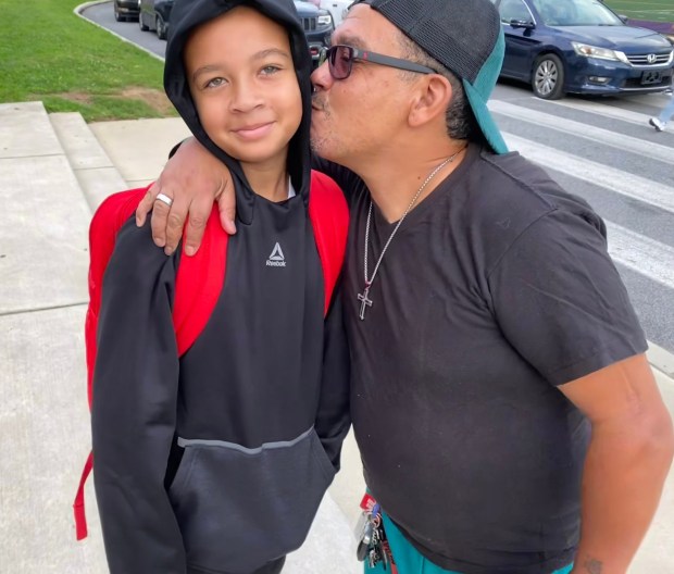 Luis Garcia Sr. gives his son Luis Jr. a kiss goodbye. (PETE BANNAN-DAILY TIMES)