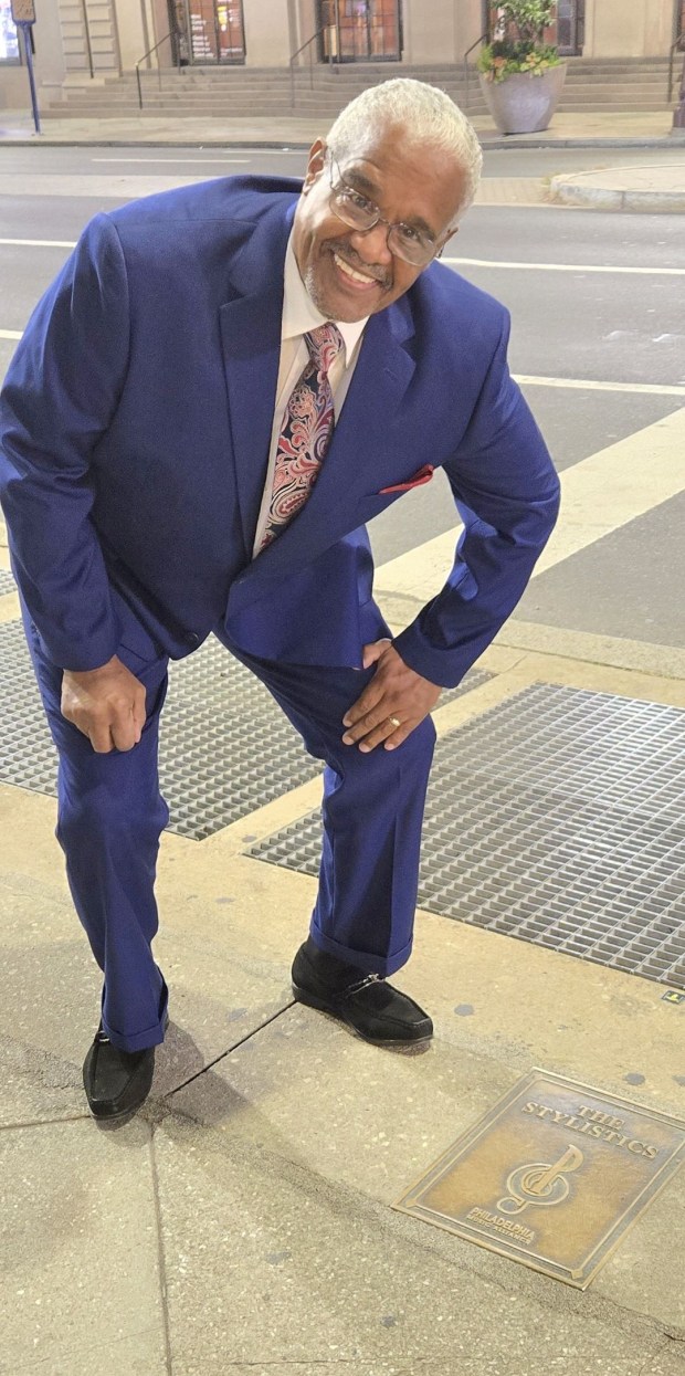 Russell Thompkins Jr. admiring the plaque that recognizes the original Stylistics, located on the Philadelphia Music Alliance Walk of Fame on the Avenue of the Arts. (COURTESY OF RUSSELL THOMPKINS JR.)