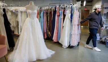 Shane Skoda, producer and studio manager, moves a rack of dresses at David's Bridal headquarters in King of Prussia.
