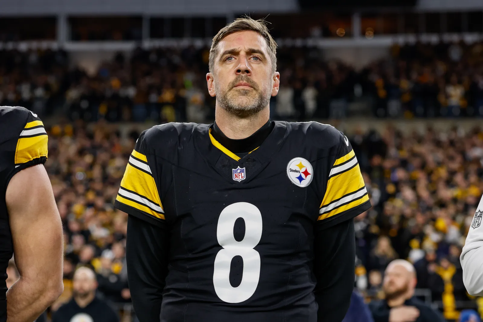 Aaron Rodgers #8 of the Pittsburgh Steelers stands for the national anthem prior to the AFC Wild Card playoff game against the Houston Texans at Acrisure Stadium on January 12, 2026 in Pittsburgh, Pennsylvania.