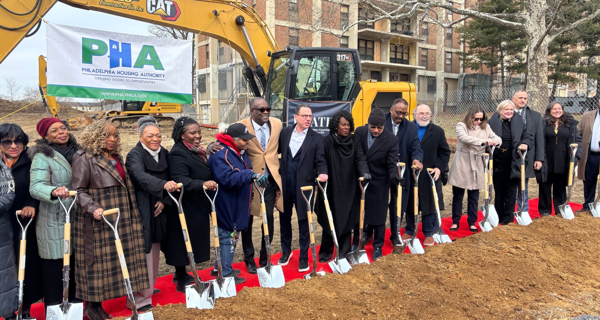 Gov. Shapiro, Mayor Parker and other dignitaries hold shovels at the groundbreaking ceremony for a PHA