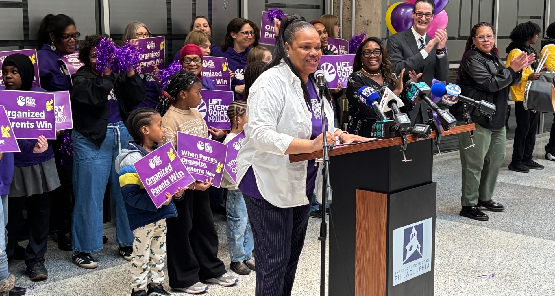 Jamila Carter stands at a podium, saying how Philadelphia teachers can no longer withhold recess or bathroom breaks as discipline