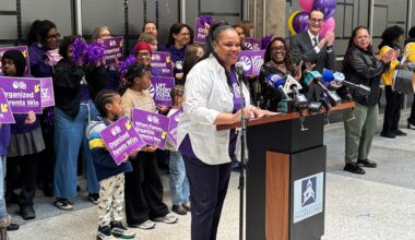 Jamila Carter stands at a podium, saying how Philadelphia teachers can no longer withhold recess or bathroom breaks as discipline