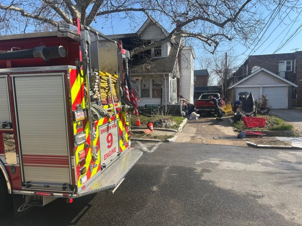 Sharon Hill firefighters mop up before departing the Kenney Avenue call. (PETE BANNAN-DAILY TIMES)