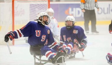 U.S. women’s sled hockey players Kaden Herchenroether and Kelsey DiClaudio laugh during the 2025 World Para Ice Hockey Women’s Championship in Dolny Kubin, Slovakia, on Aug. 30, 2025.