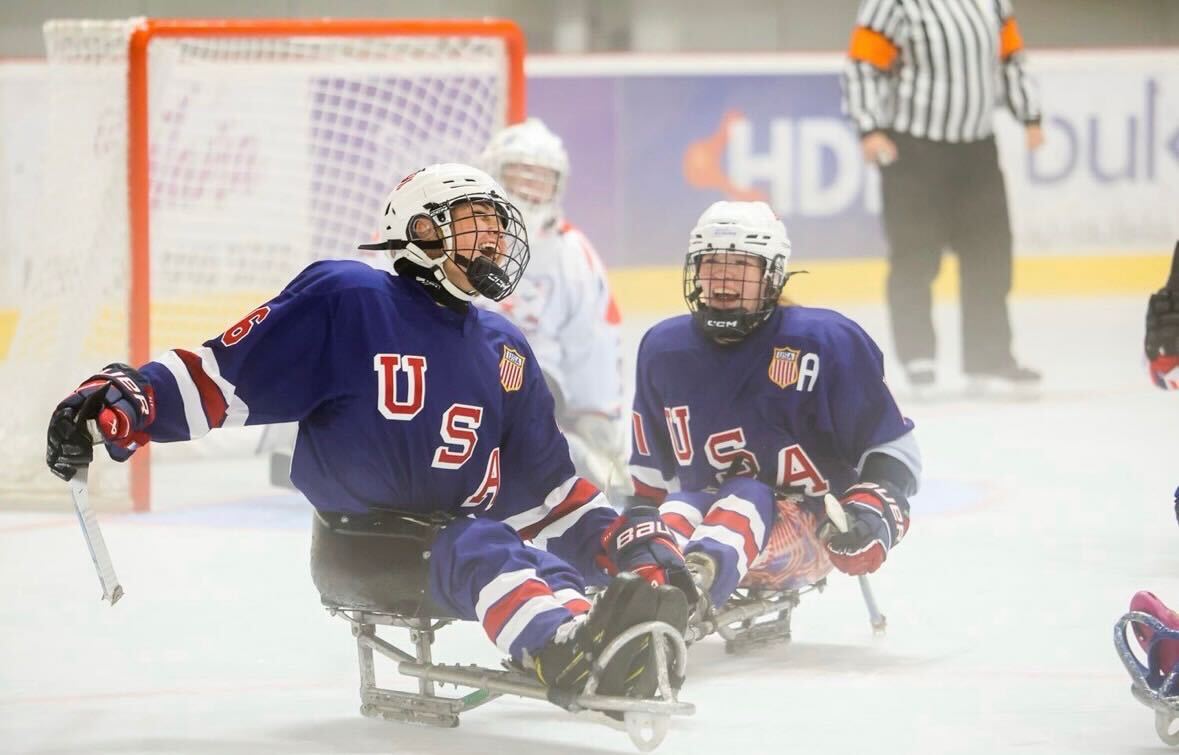 U.S. women’s sled hockey players Kaden Herchenroether and Kelsey DiClaudio laugh during the 2025 World Para Ice Hockey Women’s Championship in Dolny Kubin, Slovakia, on Aug. 30, 2025.