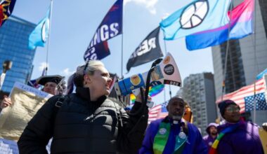 Lauren Steinmeyer, a volunteer with Indivisible Philadelphia, leads the front of the march with chants during the third No Kings Rally.