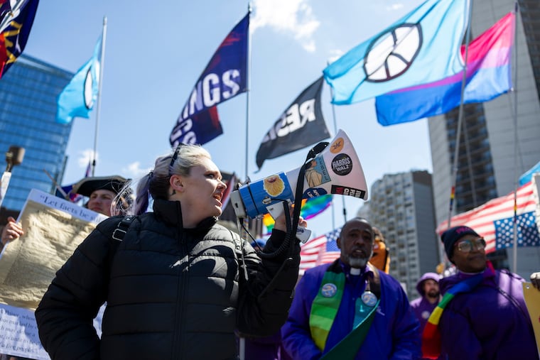 Lauren Steinmeyer, a volunteer with Indivisible Philadelphia, leads the front of the march with chants during the third No Kings Rally.
