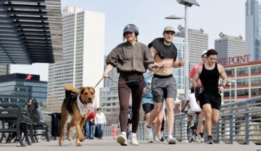 Runners and a dog walker move along the Schuylkill Banks Boardwalk earlier this month. It's been quite the month for a change of seasons.