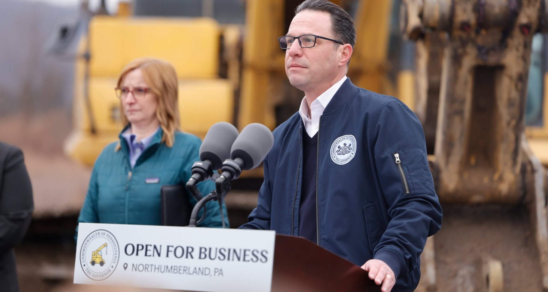 Pennsylvania Governor Josh Shapiro speaking from an outdoor podium in Northumberland County