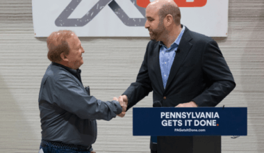 DCED Secretary Rick Siger shaking hands with company official at X-Hab 3D