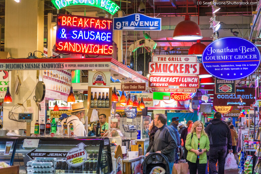 People shopping inside indoor market (© Sean Pavone/Shutterstock.com)