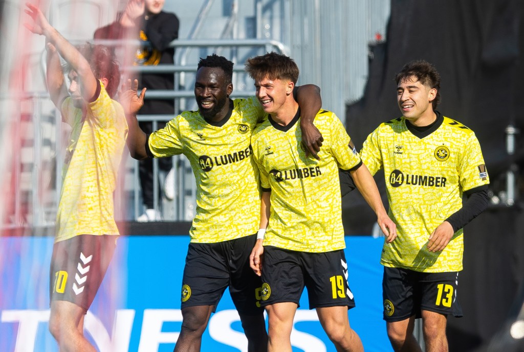 Sam Bassett (19) is joined by teammates (from left) Charles Ahl, Albert Dikwa and Max Viera after scoring his first Pittsburgh Riverhounds goal in the team's 3-2 win at Loudoun United FC on March 14, 2026 at Segra Field in Leesburg, Va. (Photo: Mallory Neil/Riverhounds SC)