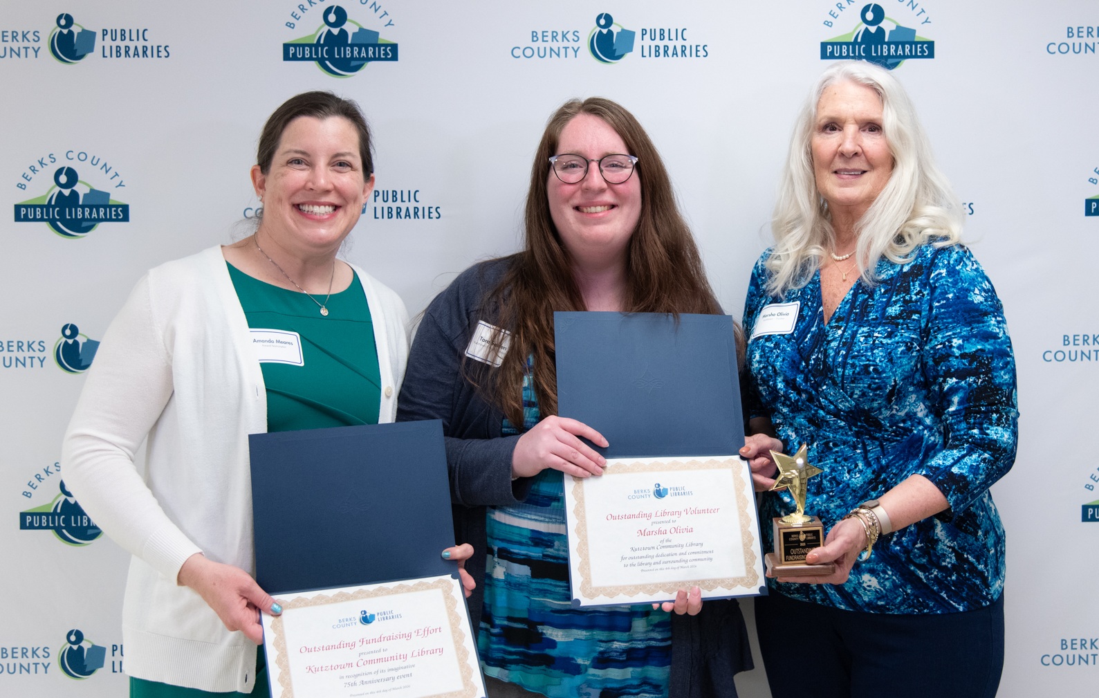 Kutztown Community Library Youth Coordinator Tara Sanders, left, accepted the...