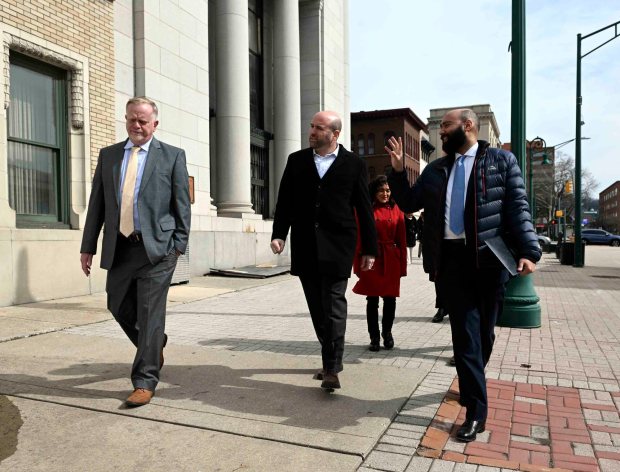 Pennsylvania Department of Community and Economic Development Secretary Rick Siger, center, walks down Penn Street with Habitat for Humanity development director Doug Long, left, and Reading Managing Director Jack R. Gombach following a press conference in the former bank at Fifth and Penn streets on Monday, March 2, 2026. (BILL UHRICH/READING EAGLE)