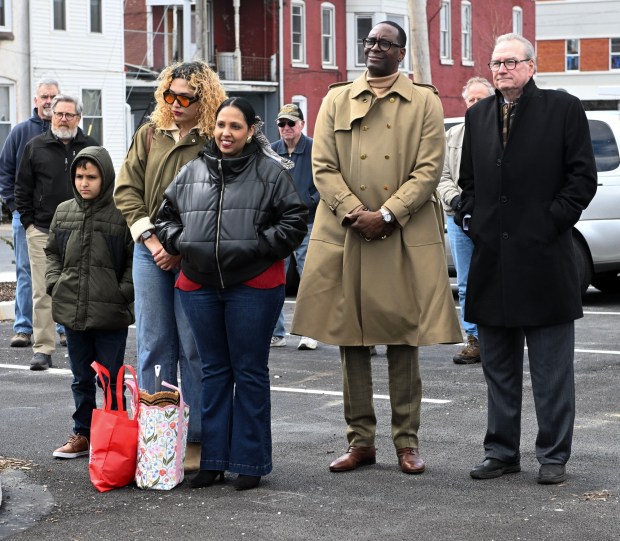New homeowner Guadalupe, center, and her children Vanessa, 19, and Willie, 9, attend the dedication of their Habitat for Humanity home in the 900 block of Douglass Street on Tuesday, March 17, 2026. Next to the family is Dr. Khalid Mumin, Reading School superintendent, and Timothy J. Daley, Habitat executive director. (BILL UHRICH/READING EAGLE)