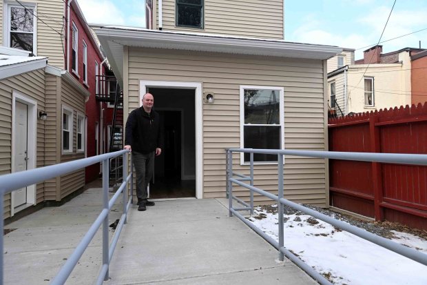 Hope Rescue Mission CEO Robert Turchi stands on the ramp leading to an ADA-compliant bedroom at the mission's community housing at 131-133 S. Ninth St. (BILL UHRICH/READING EAGLE)