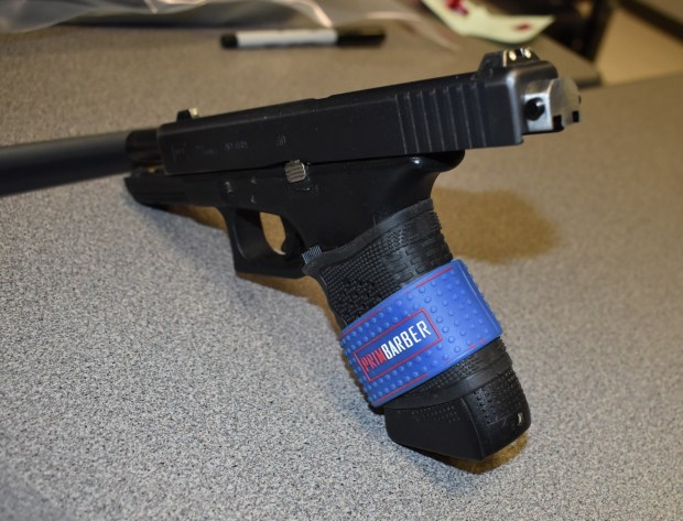 A .40-caliber Glock handgun with a "switch" is among the evidence seized by Berks County detectives in a raid at the residence of Angel Benitez in the 100 block of West Elm Street on Friday. (Courtesy of Berks County detectives)