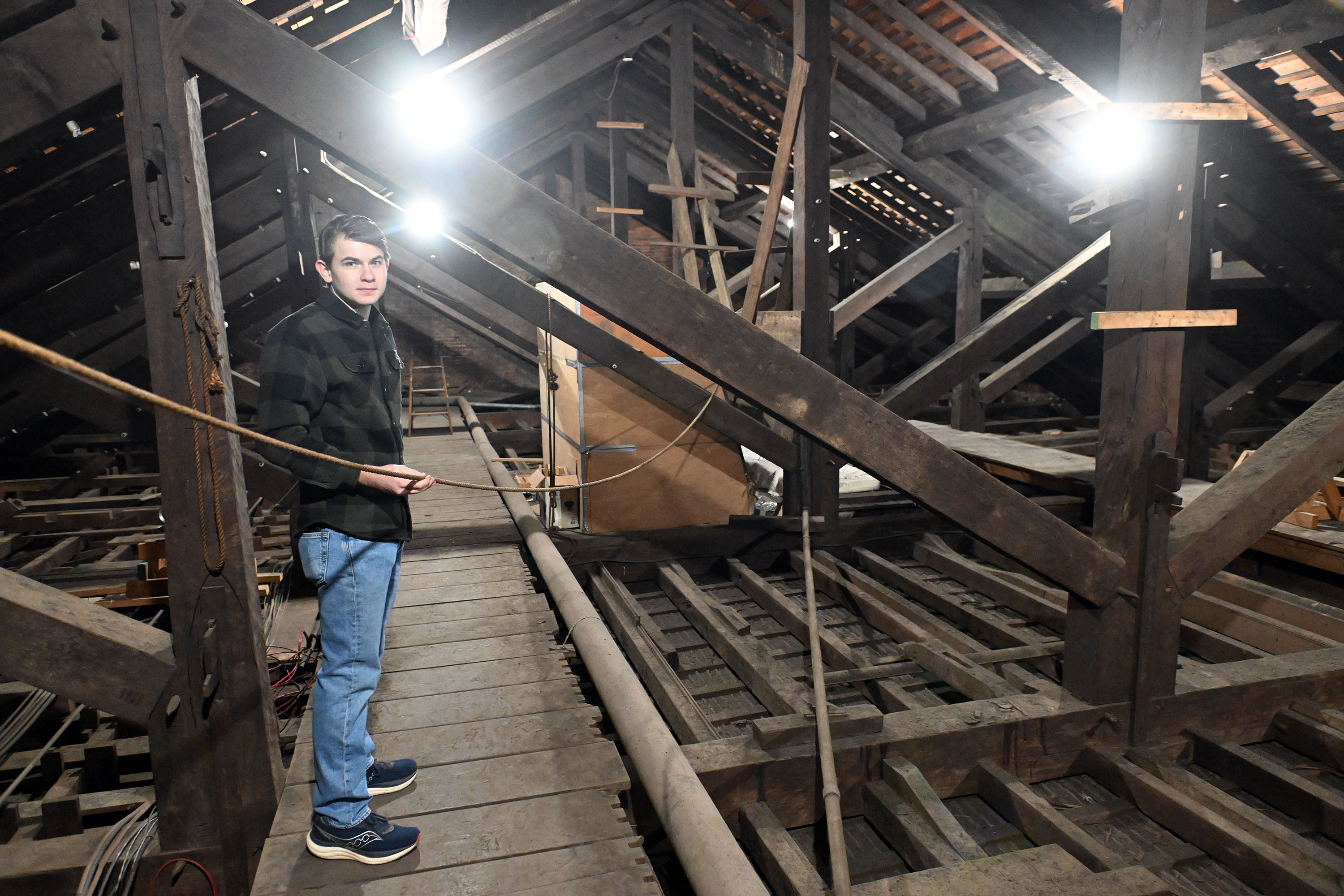 Alexander Shuman, 16, stands in the attic of First United...