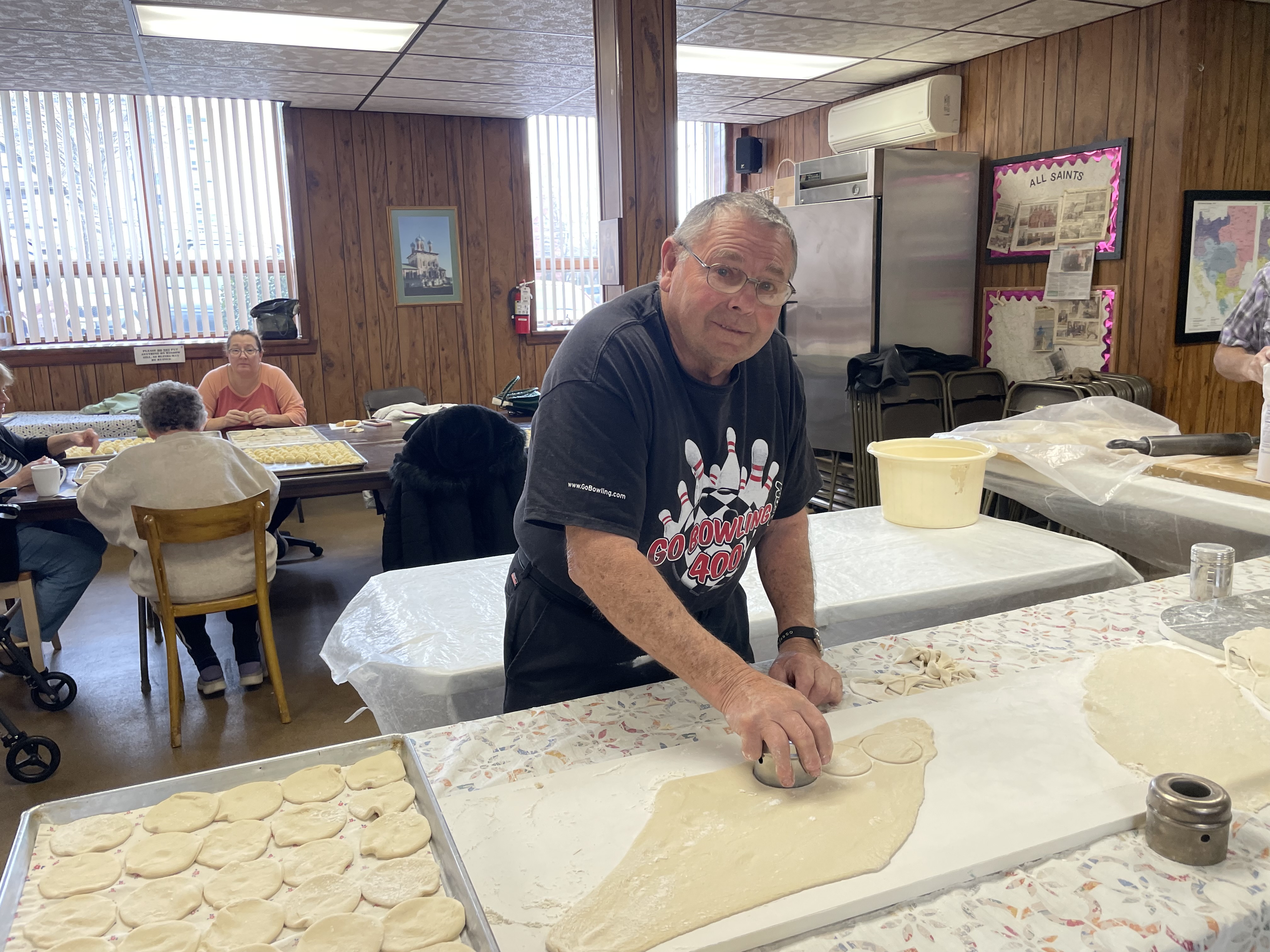 Mike Prestys cuts out the shape of the pierogies for...