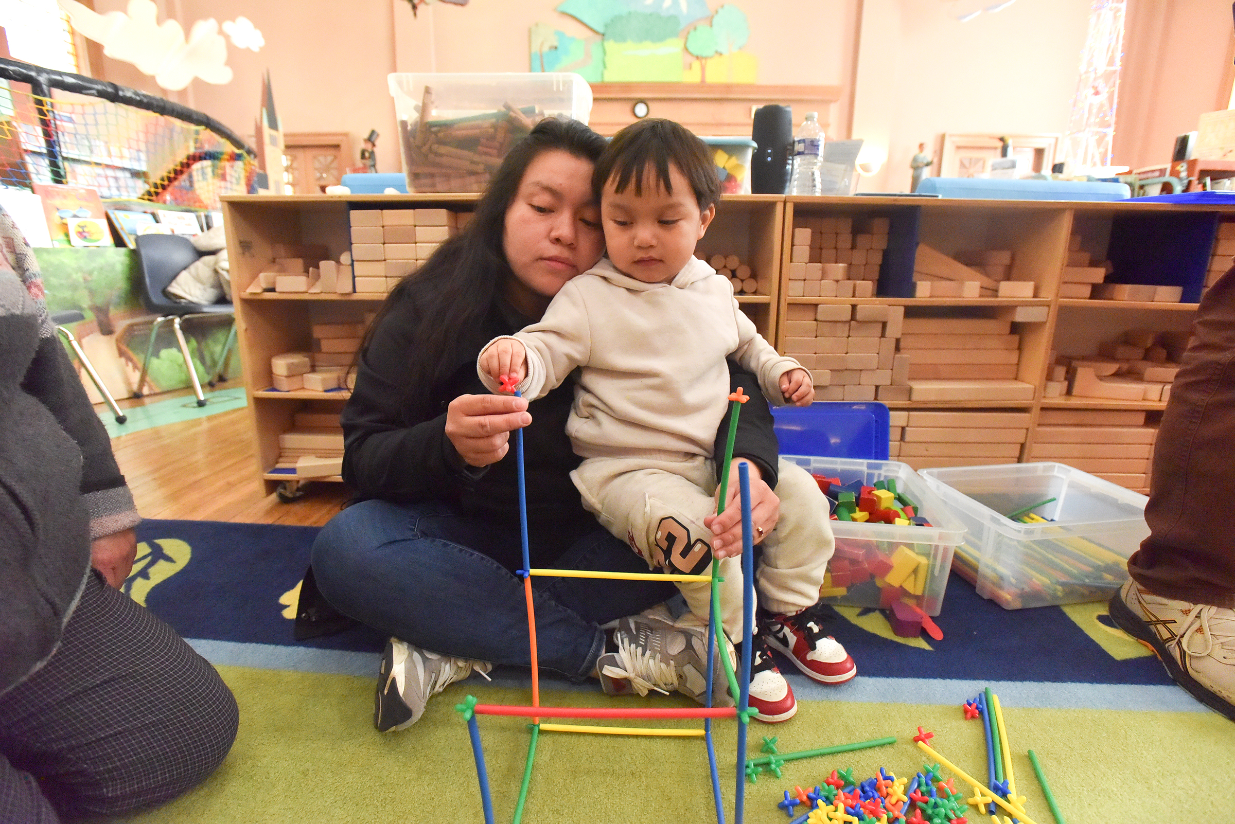 Stephanie Chimbo, of Scranton, helps her son Liam Yunga, 2,...