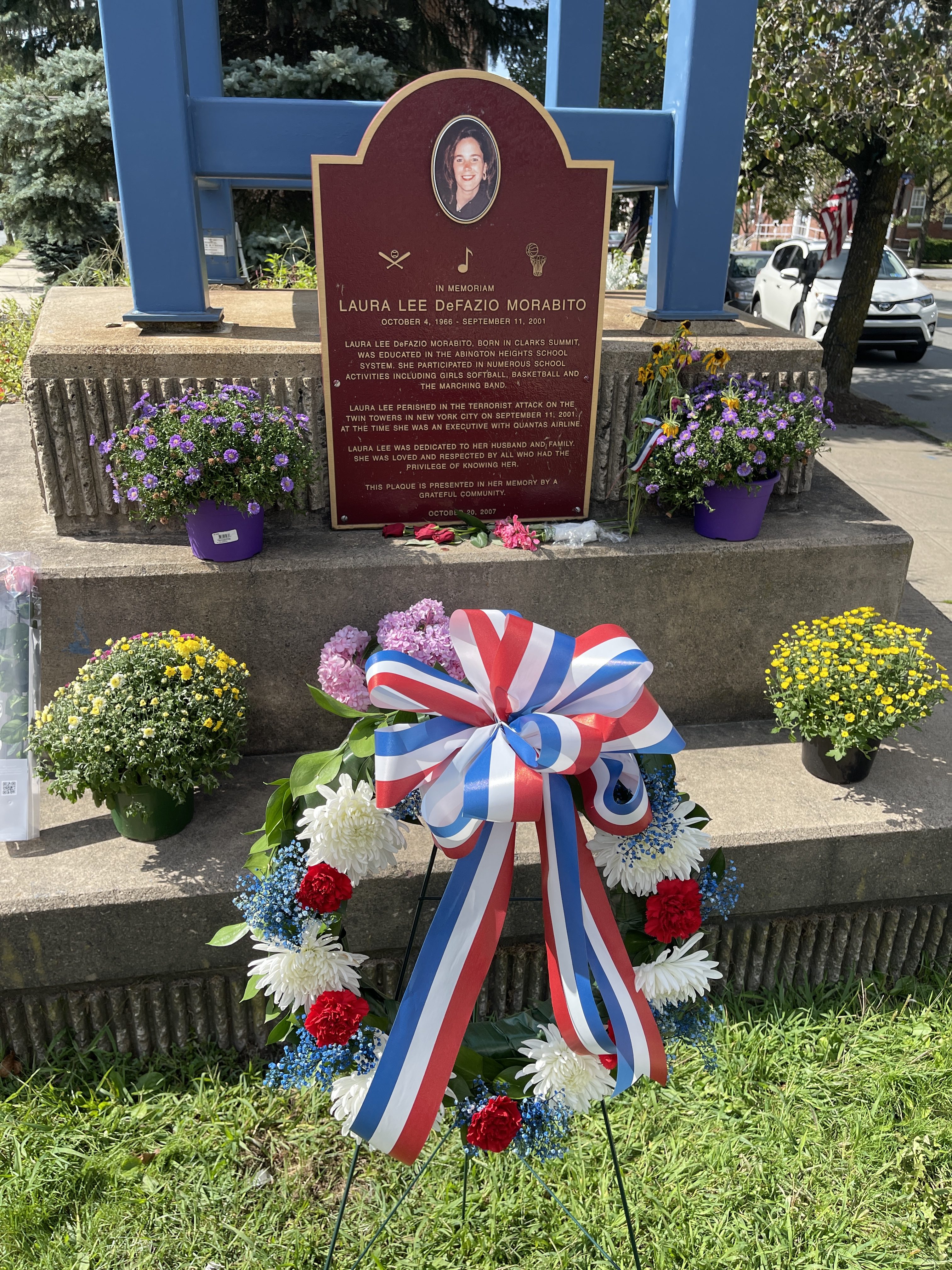 A wreath sits at the base of a plaque dedicated...