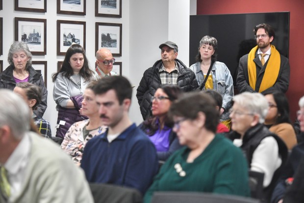 People stand against the wall in the crowded board room during the Lackawanna County Commissioners Meeting in the county government center in Scranton Wednesday, March 4, 2026. (SEAN MCKEAG / STAFF PHOTOGRAPHER)