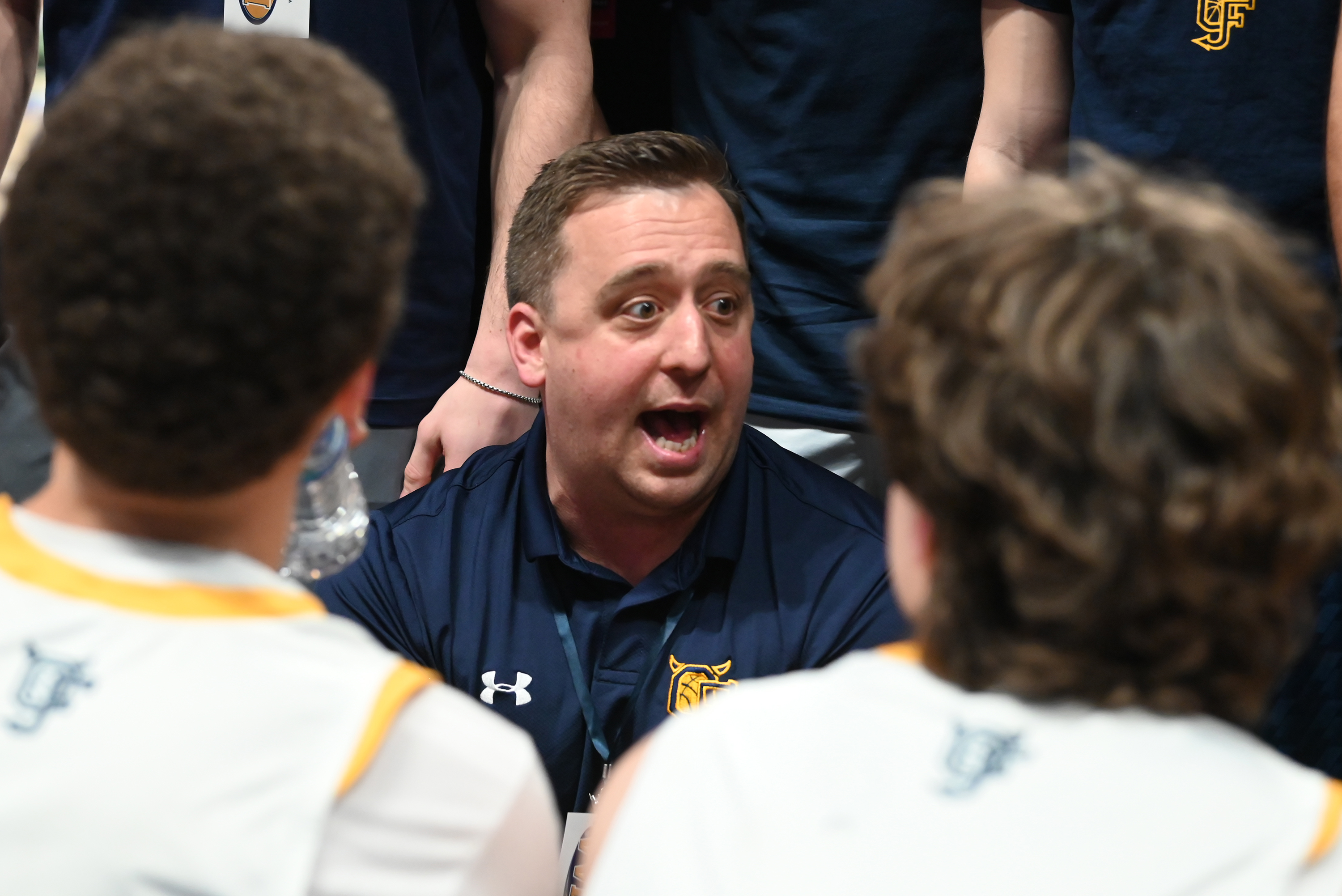 Old Forge’s head coach JJ Thomas talks to his players...