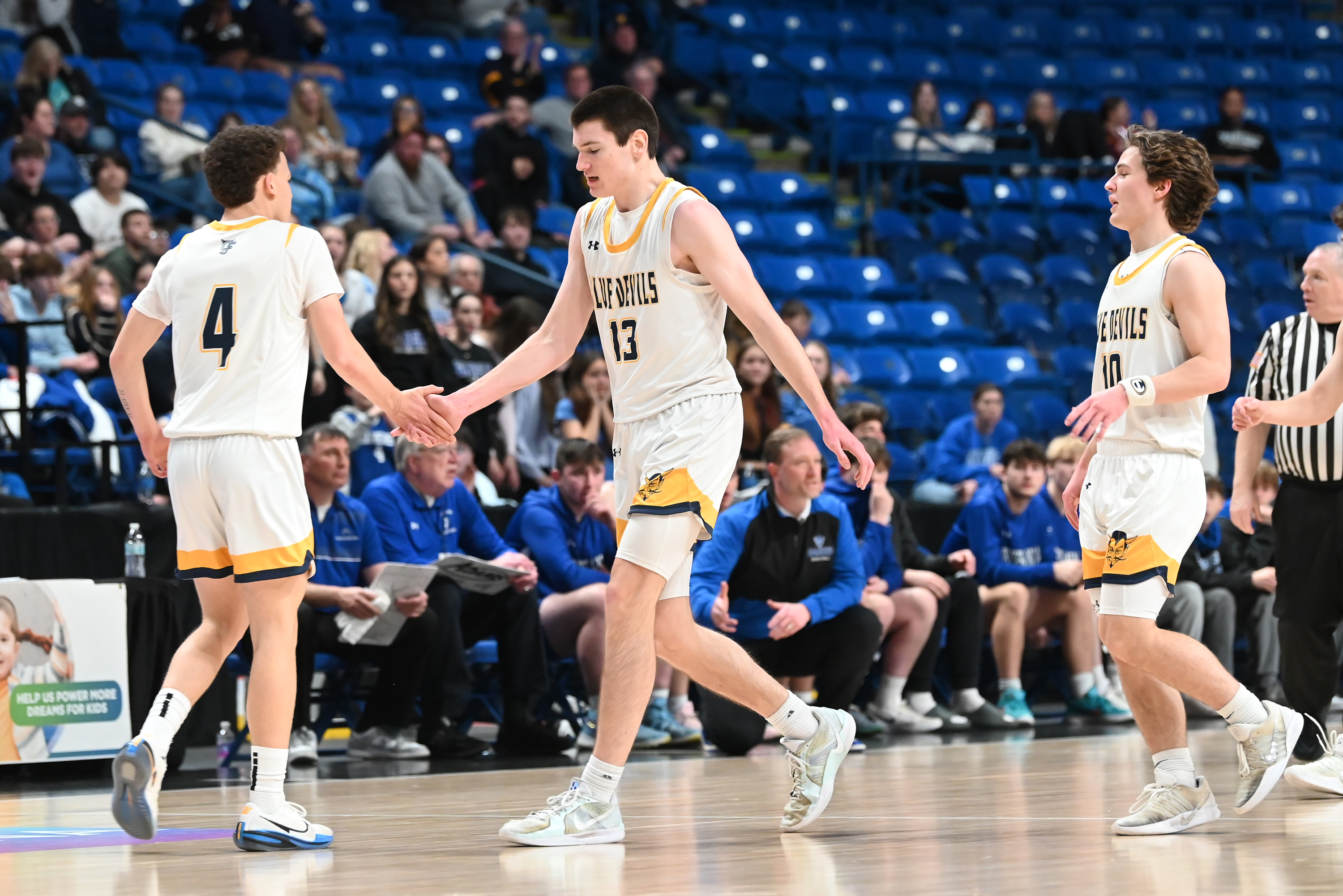 Old Forge’s Logan Fanning shares a high five with teammate...