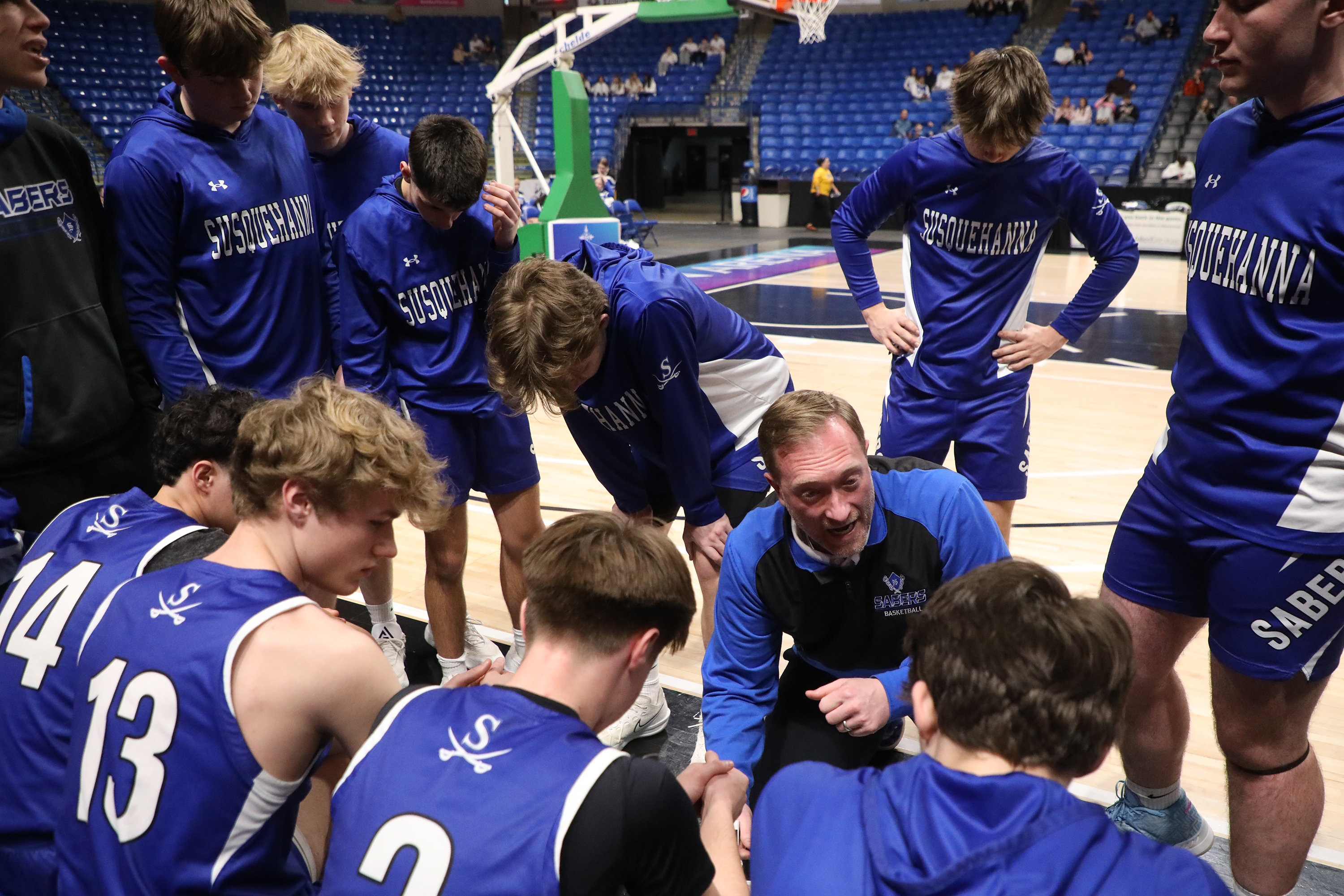 Susquehanna’s head coach Lawrence Tompkins talks to his players before...