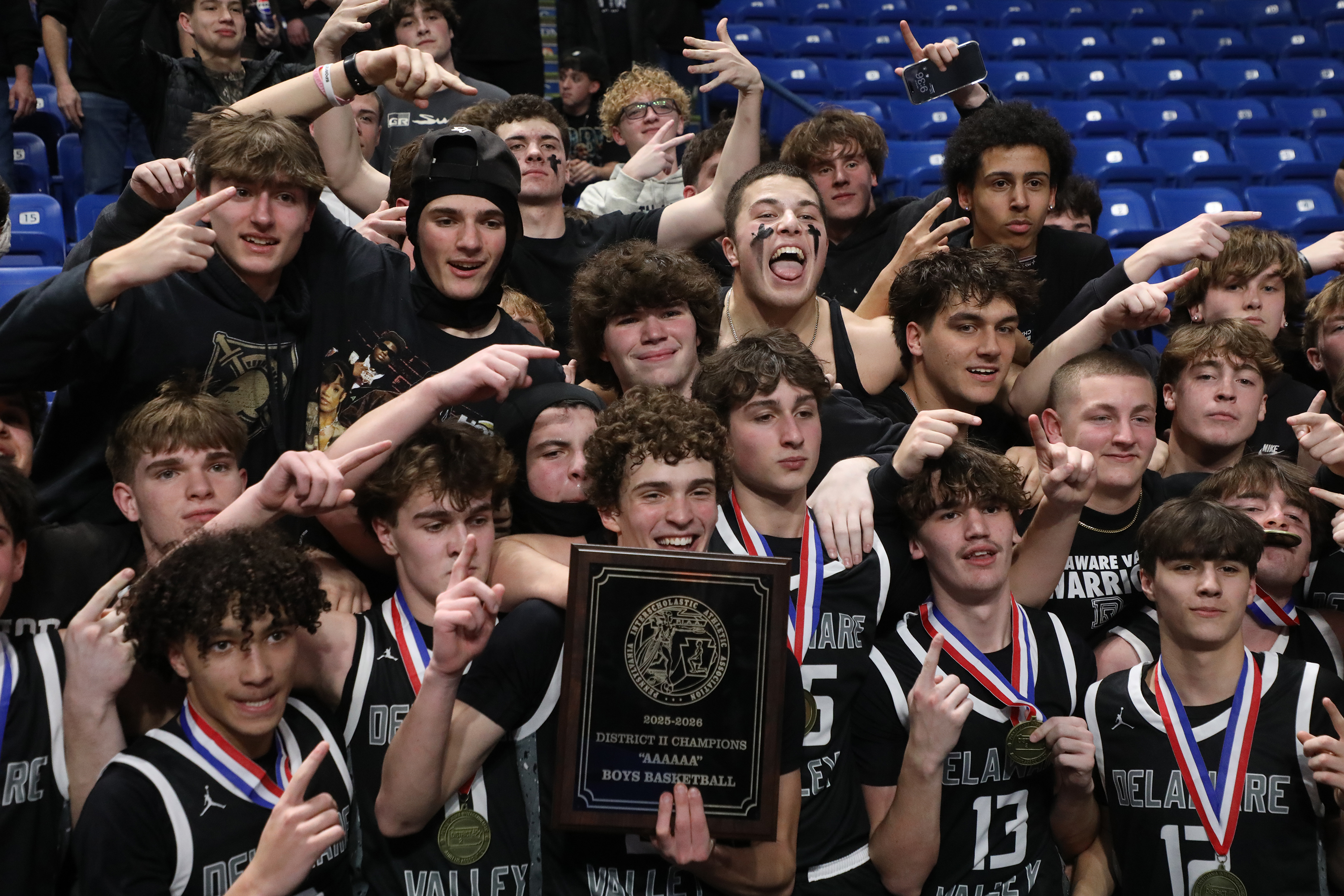 Delaware Valley players pose with their student section after winning...