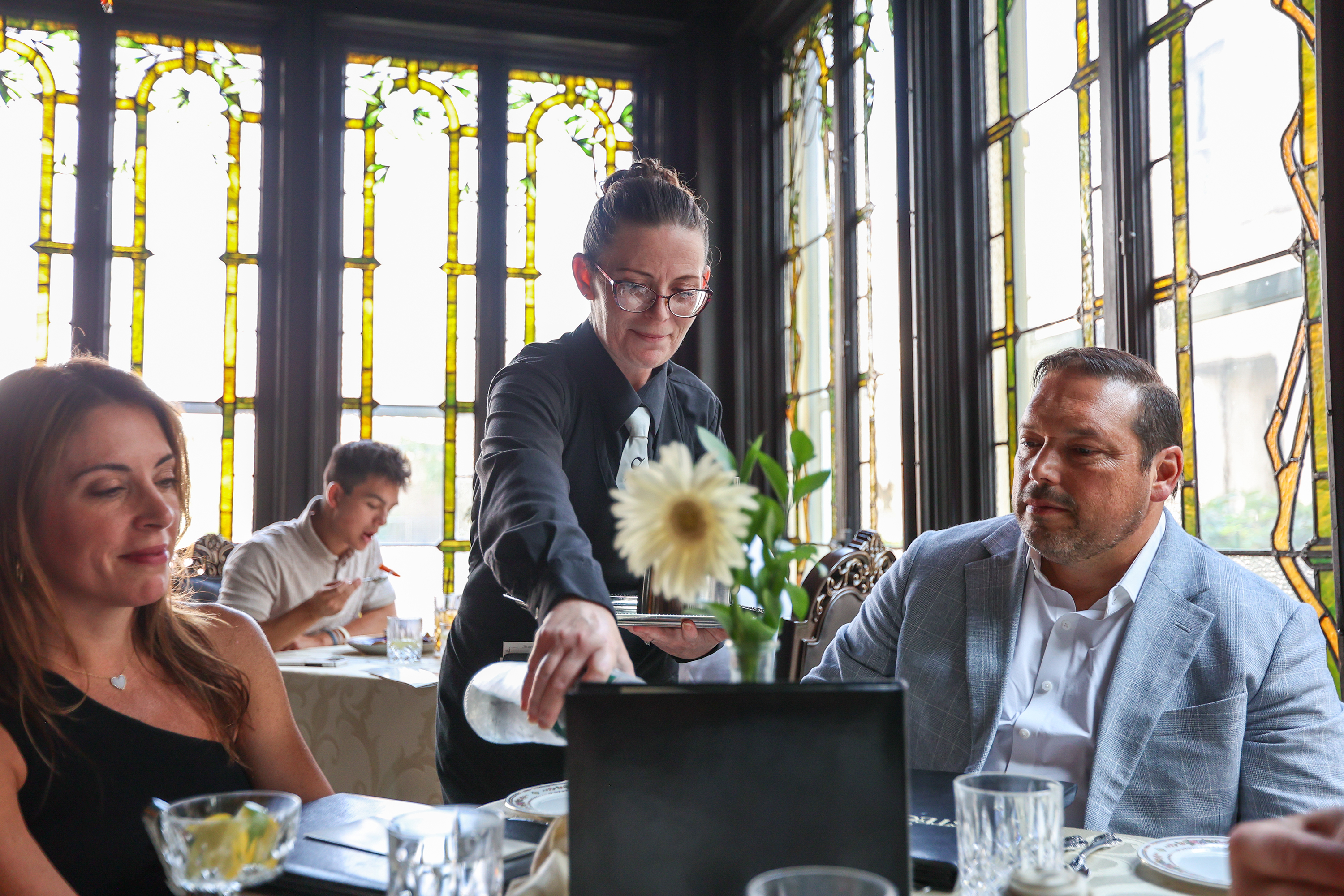 Shara Salata-Sweet pours water for a table at The Stegmaier...