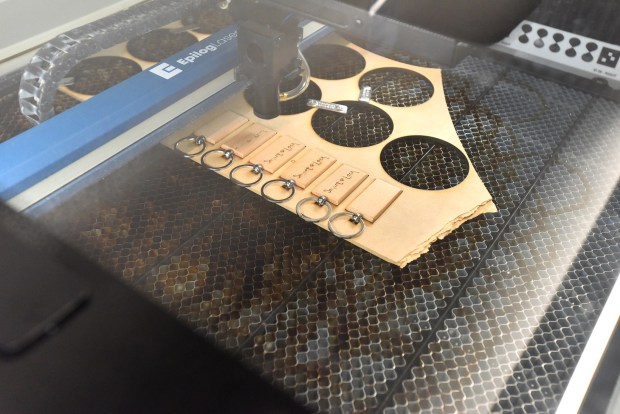 A laser wood cutter creates the end result of designs created by Old Forge students during an entrepreneurial workshop at the University of Scranton's IDEA Center in Weiss Hall on the Scranton campus Thursday, March 19, 2026. (SEAN MCKEAG / STAFF PHOTOGRAPHER)