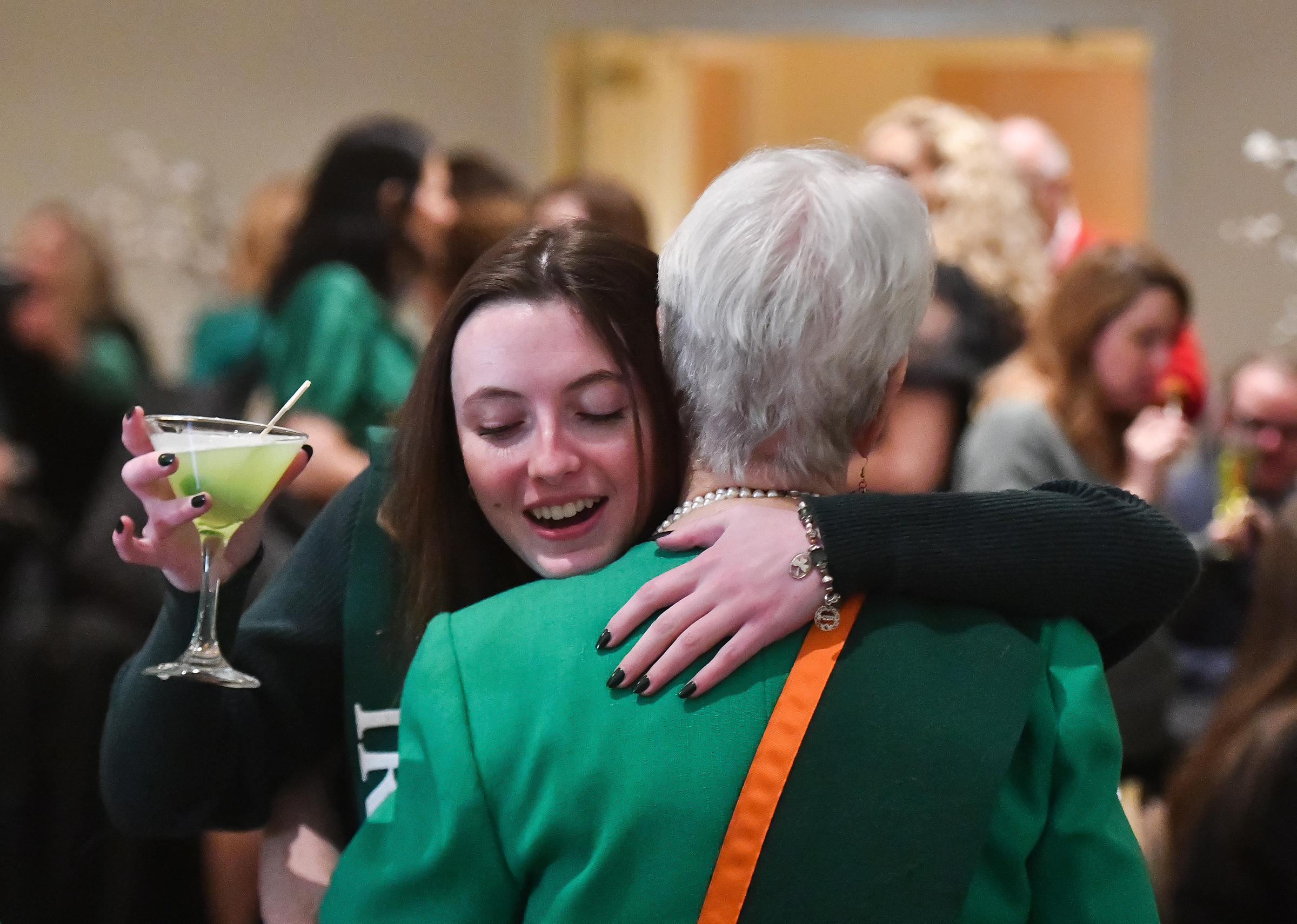 Lauren Berry hugs her grandmother Gerrie Carey, both members of...