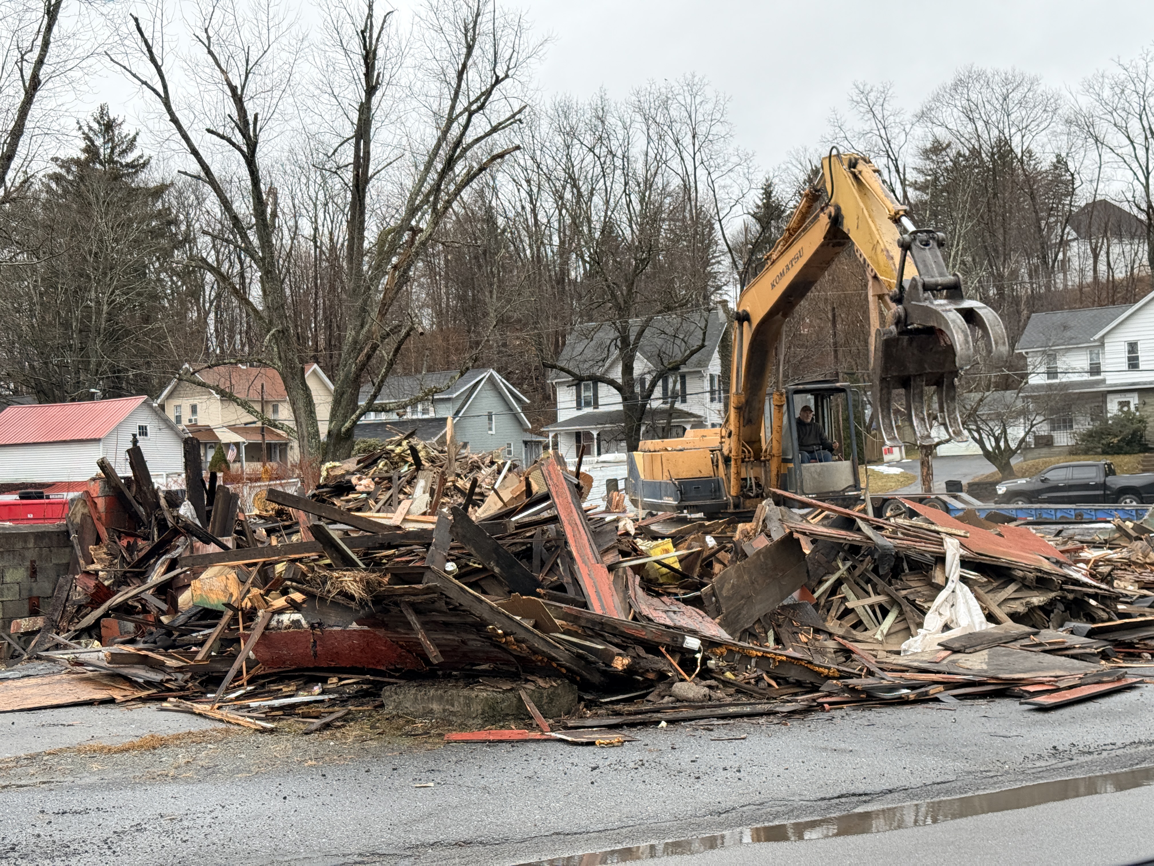 A backhoe demolishes the former Miles Auto Parts store. Ron...