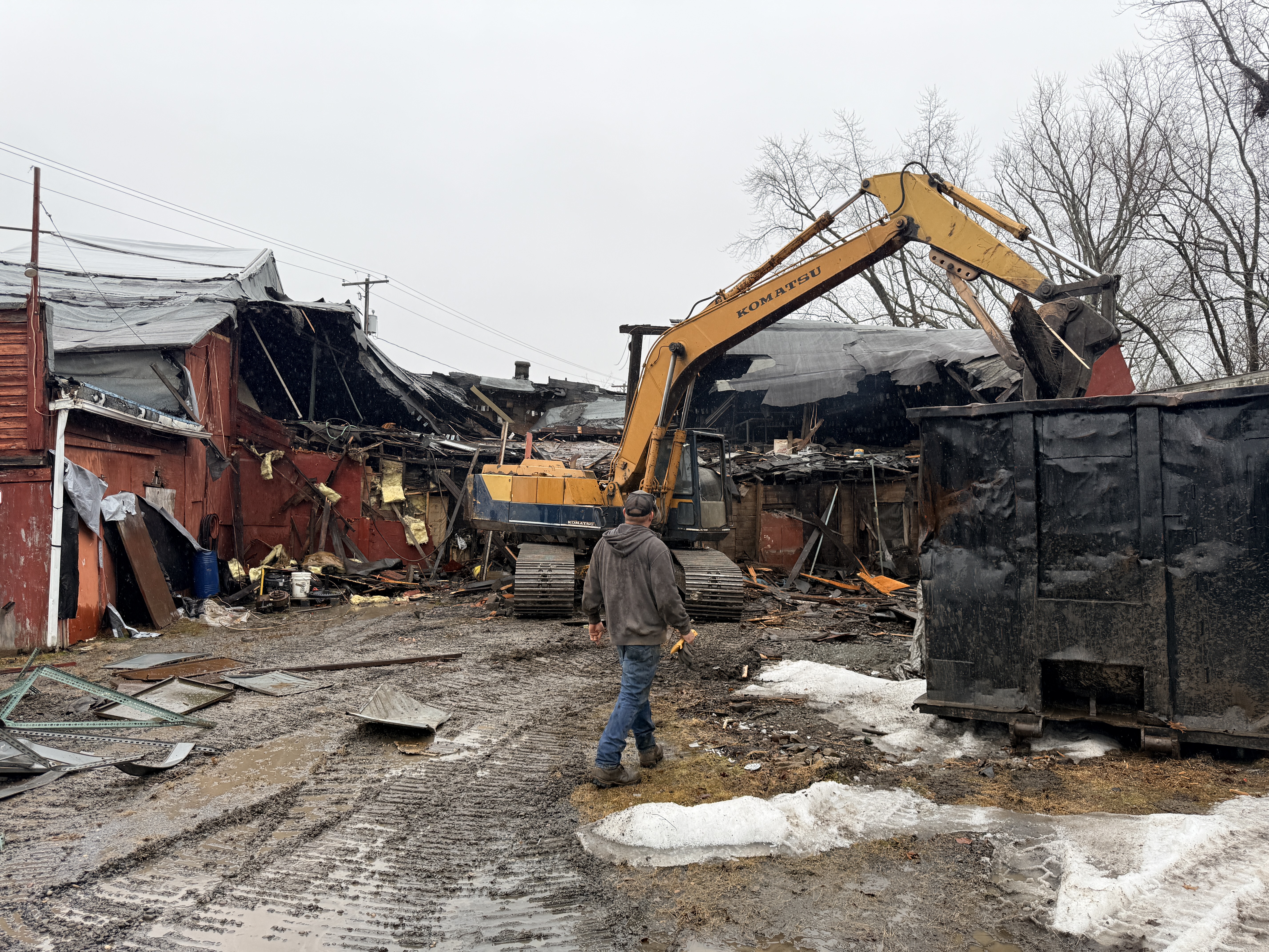 A backhoe demolishes the former Miles Auto Parts store. Ron...