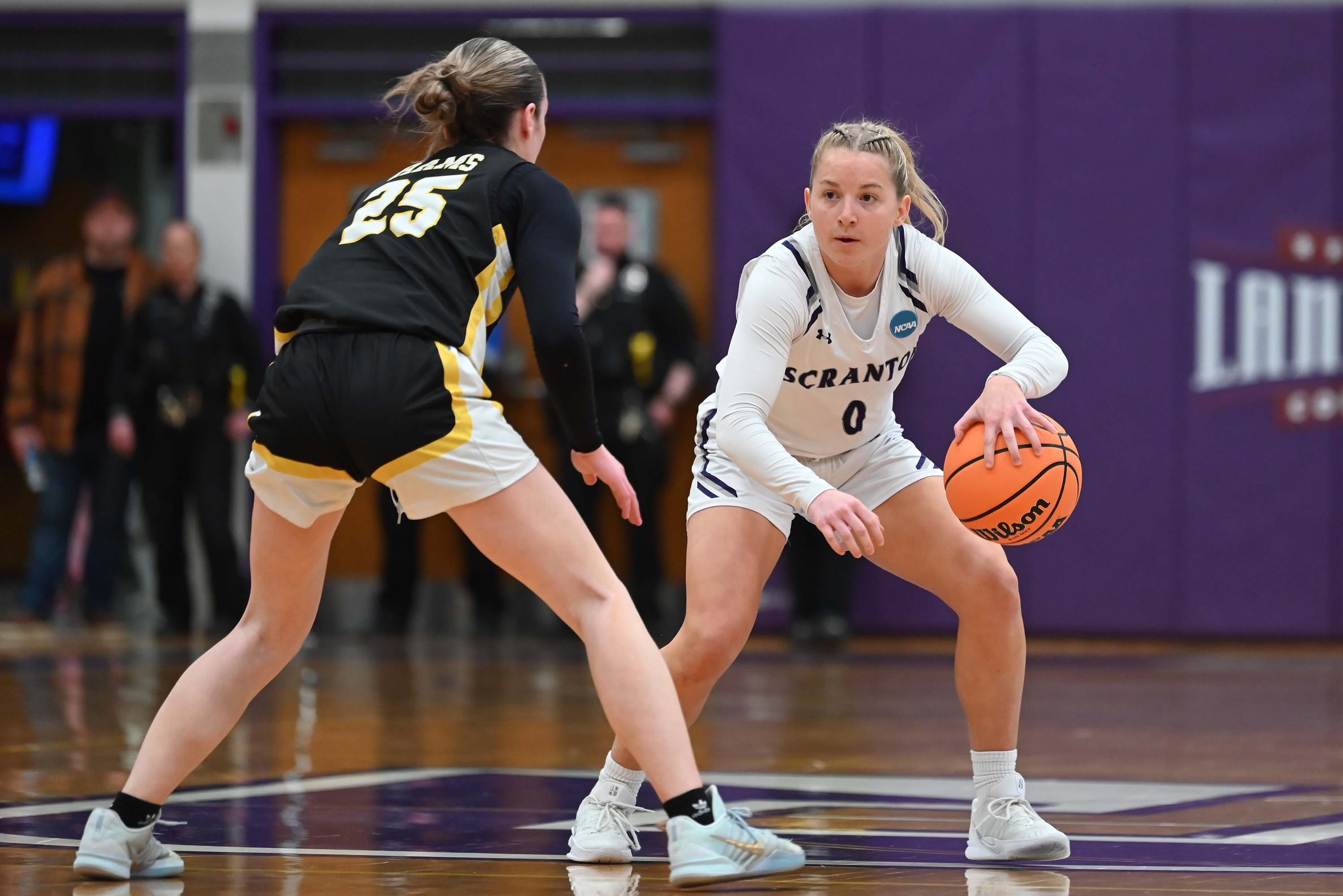Framingham State’s Ava Mckeon defends University of Scranton’s Selena Cieszko...
