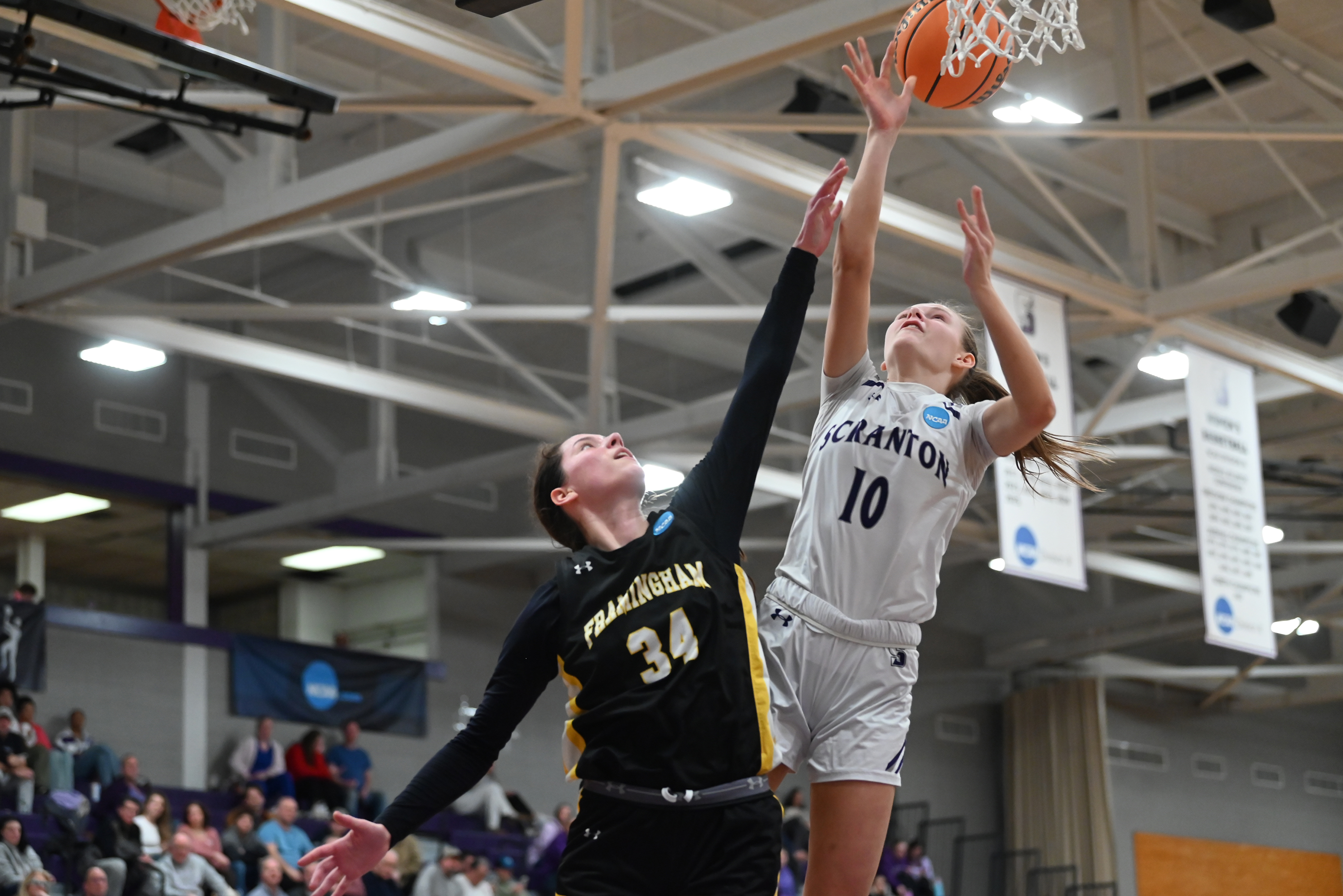Framingham State’s Abigail Martin defends University of Scranton’s Kelsey Miedreich...