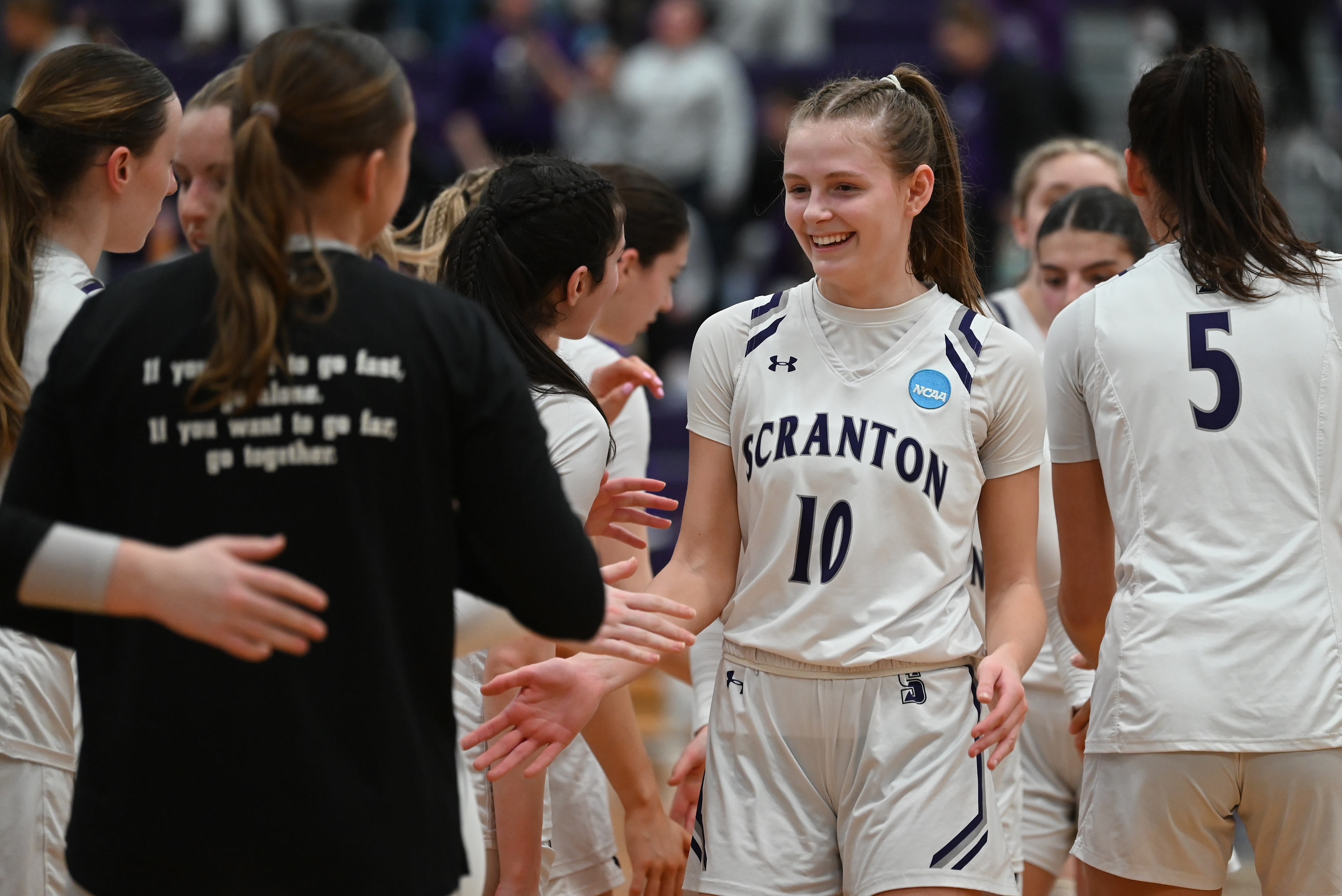 University of Scranton’s Kelsey Miedreich high fives her teammates after...