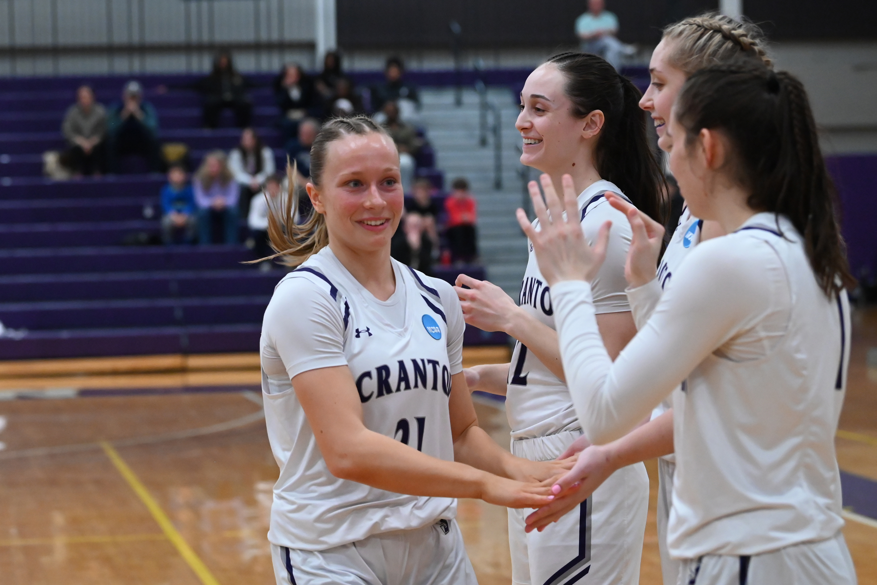 University of Scranton’s Meghan Lamanna high fives her teammates as...