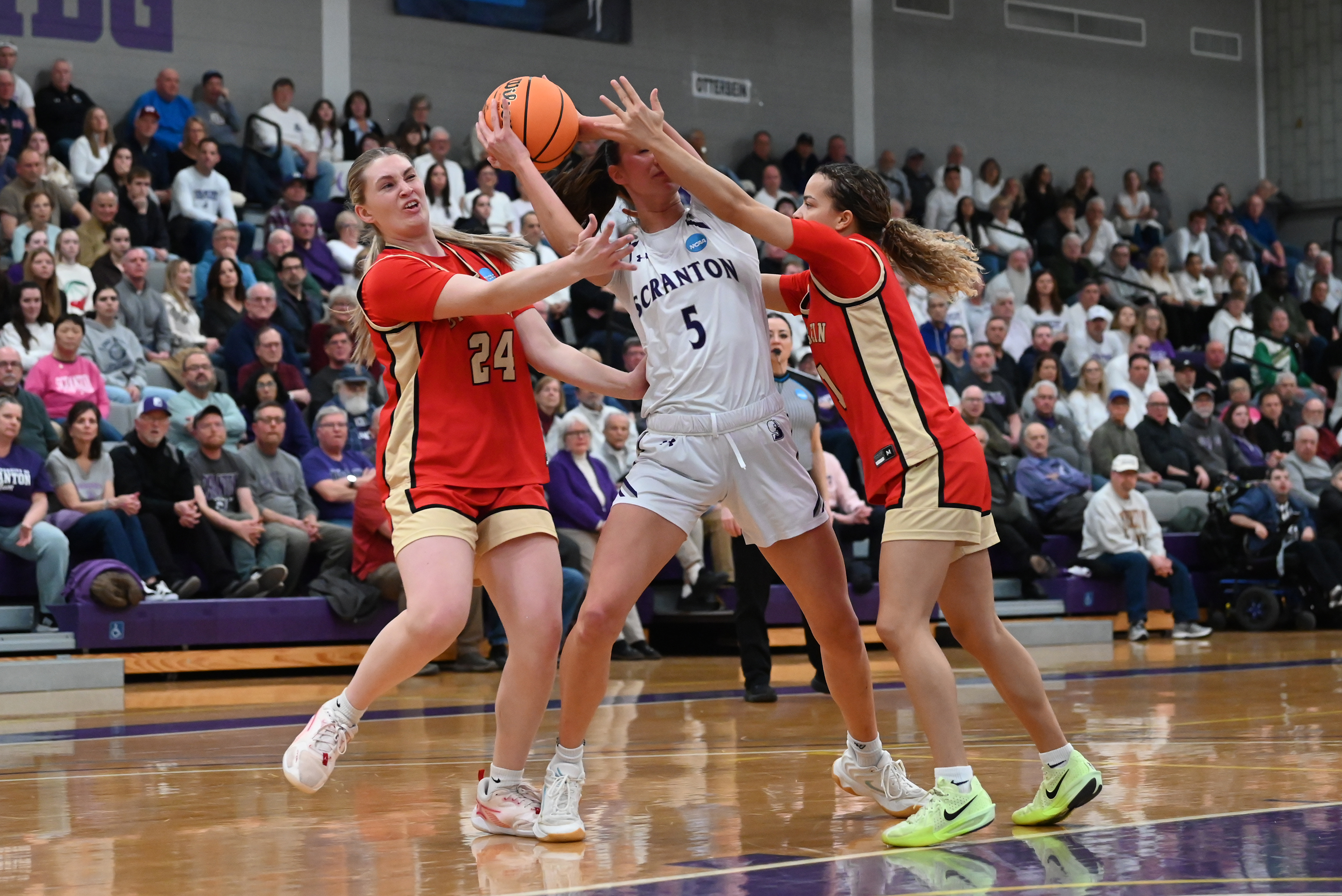 Otterbein’s Nicole Terry (24) and Kiara Hudgins (5) defend University...