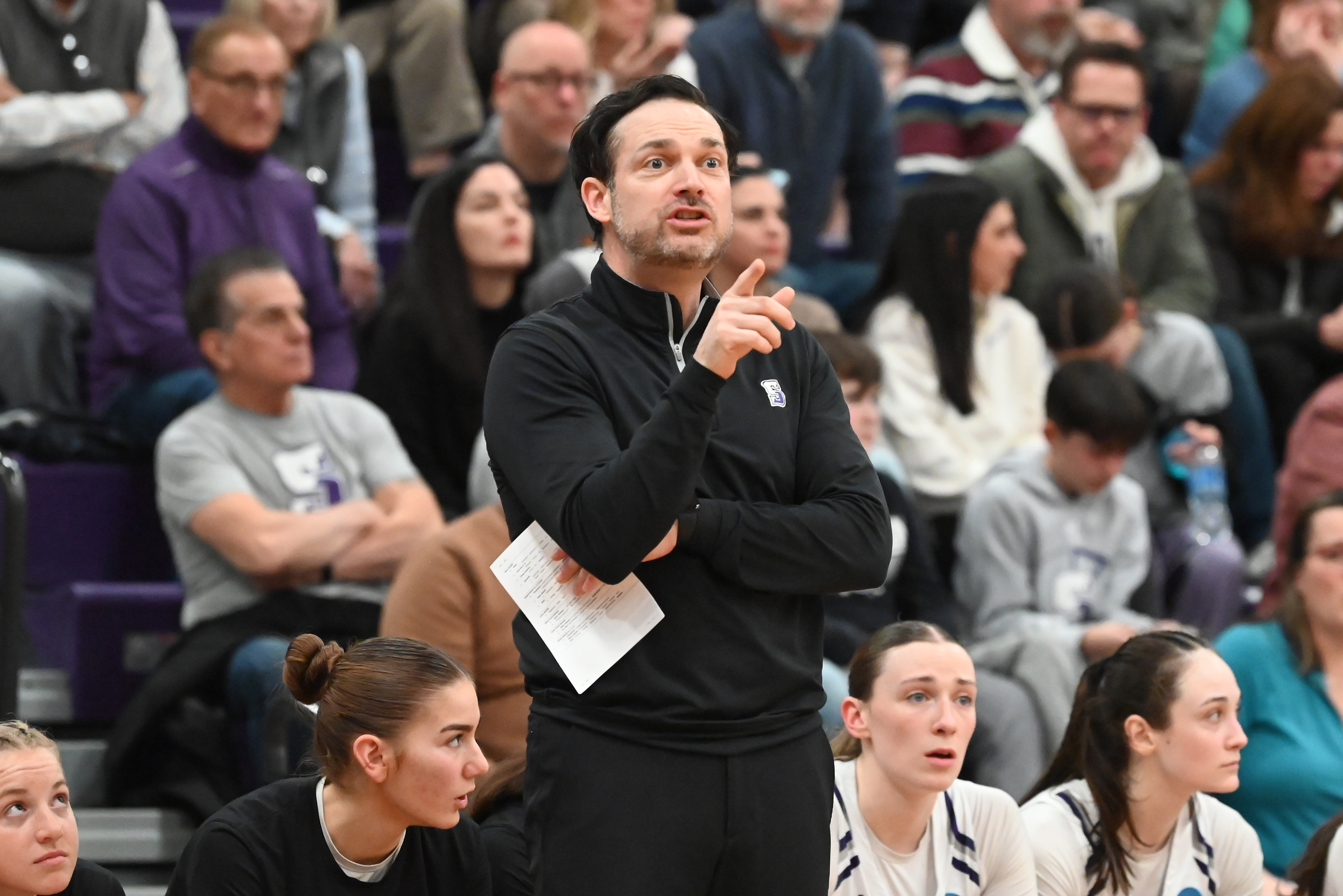 University of Scranton’s head coach Ben O’Brien guides his players...