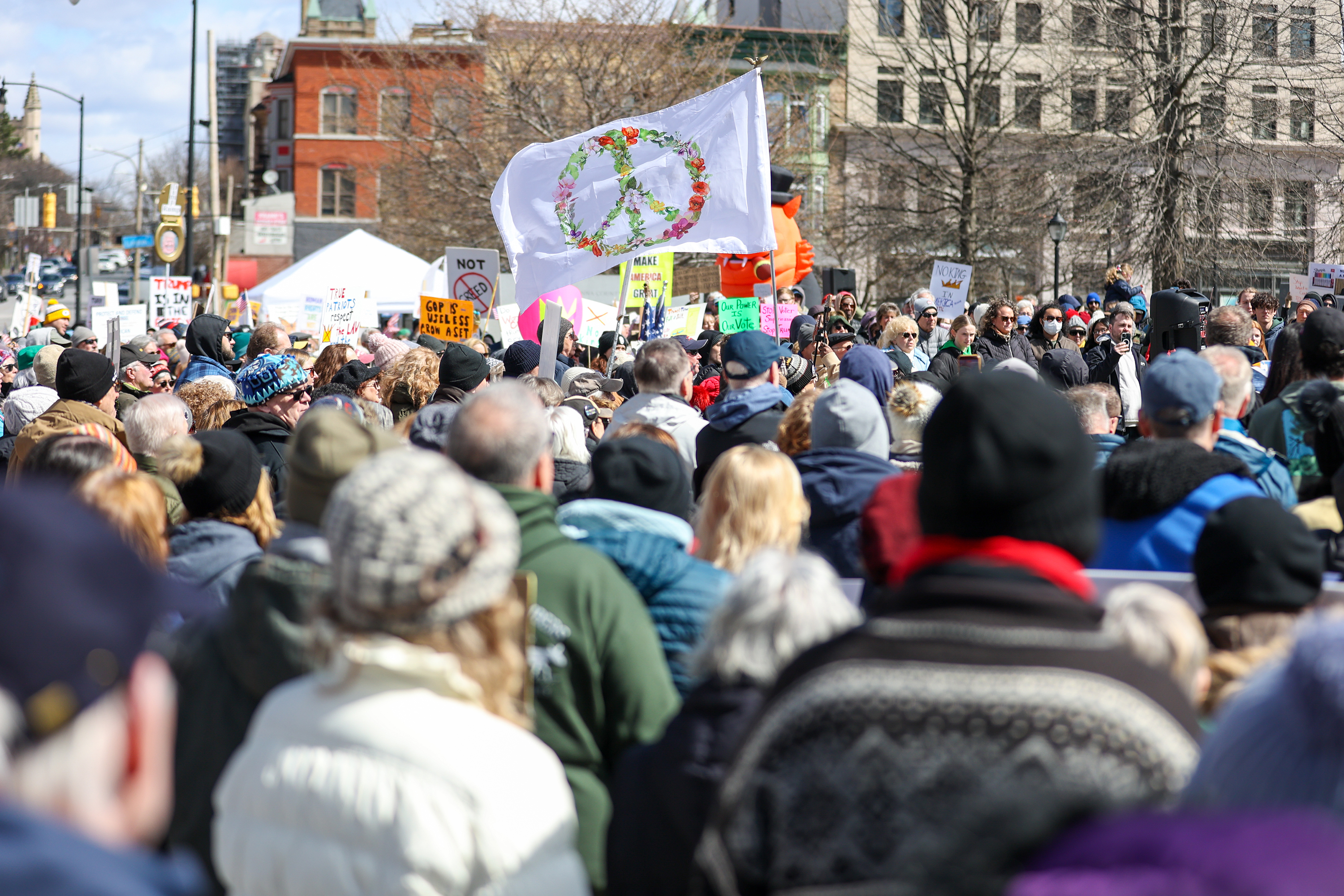An attendee waves a flag with a peace symbol during...