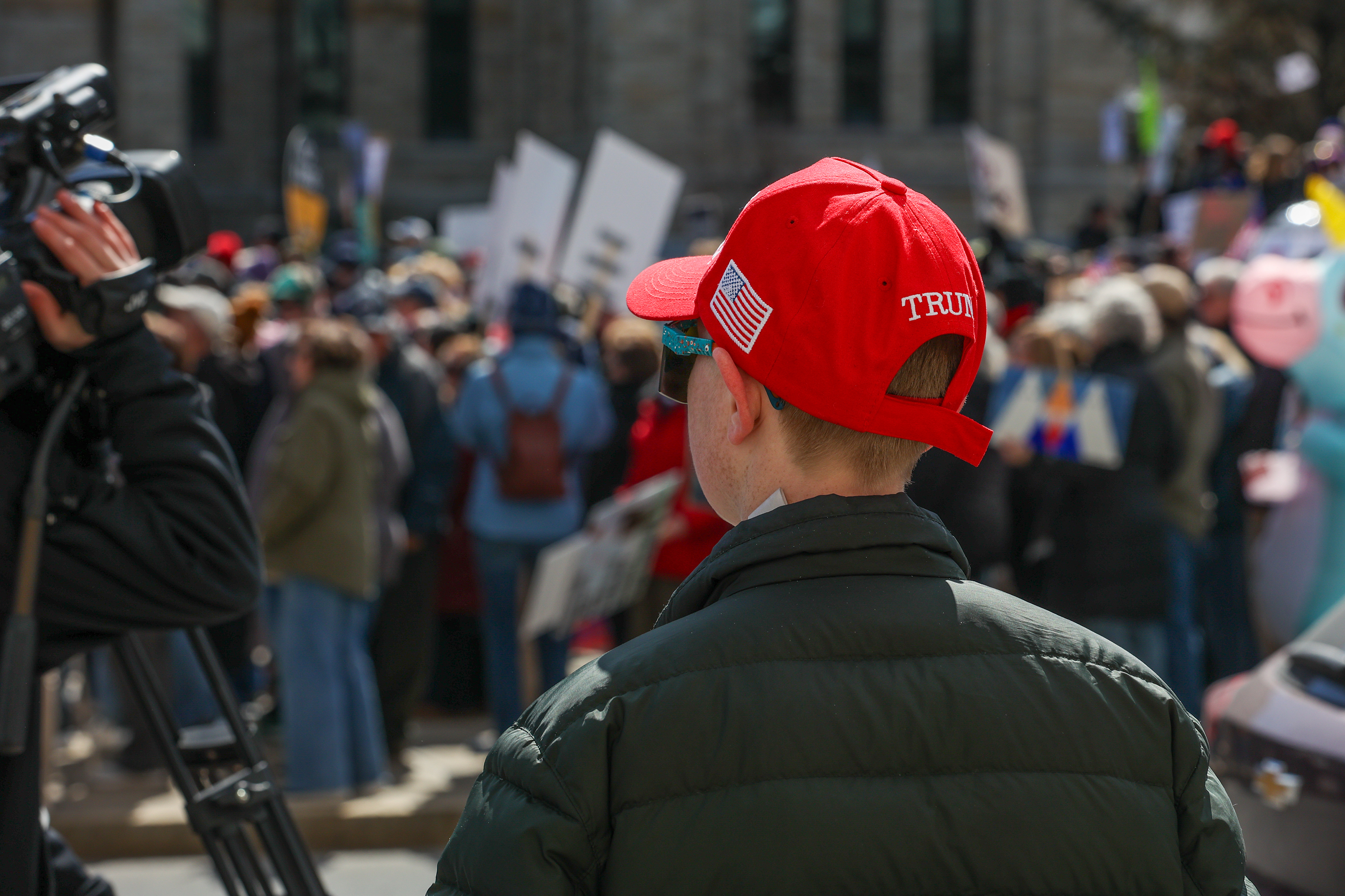 A dissenter looks on from across Washington Ave. during the...