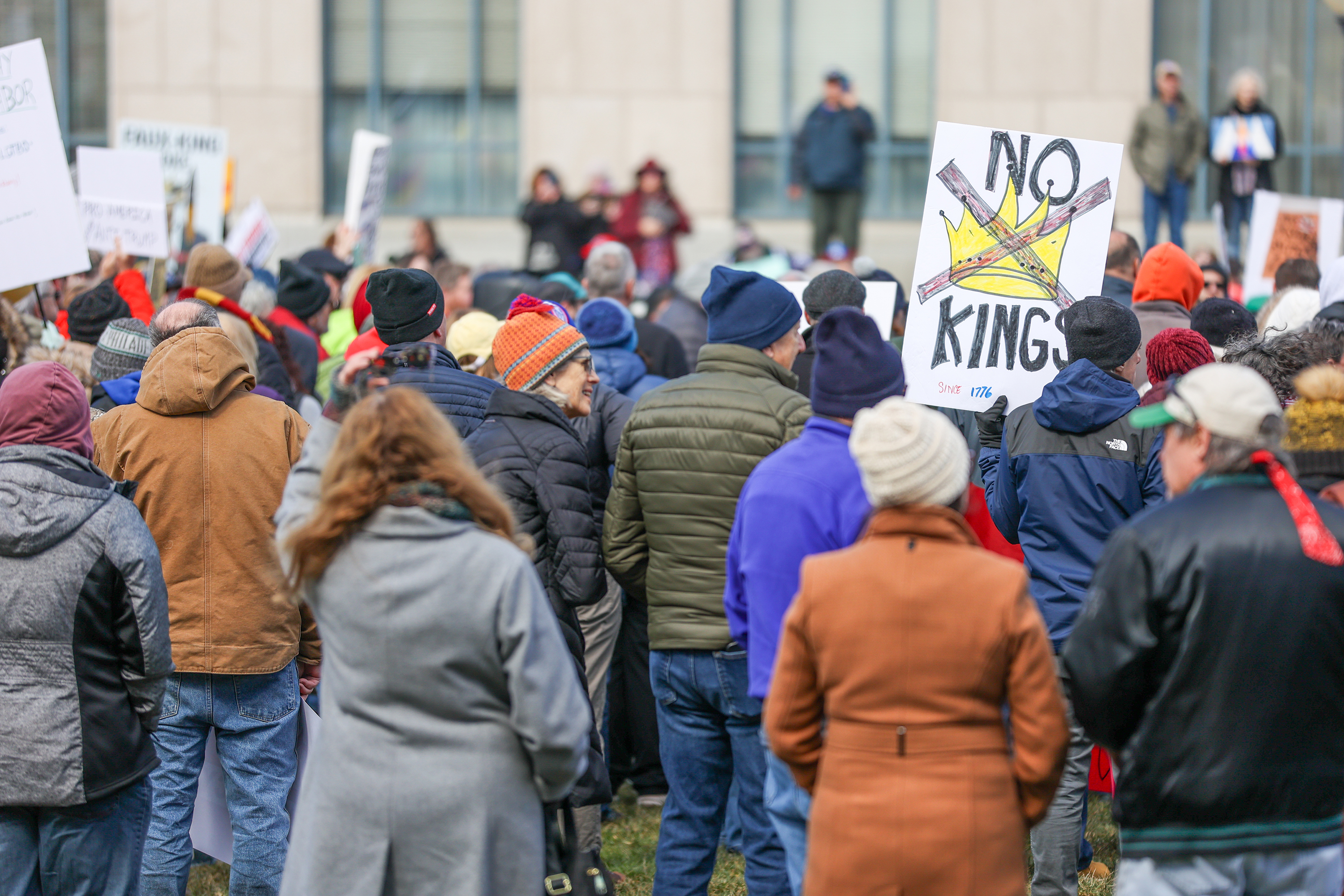 Attendees gather on Courthouse Square and hold their signs during...