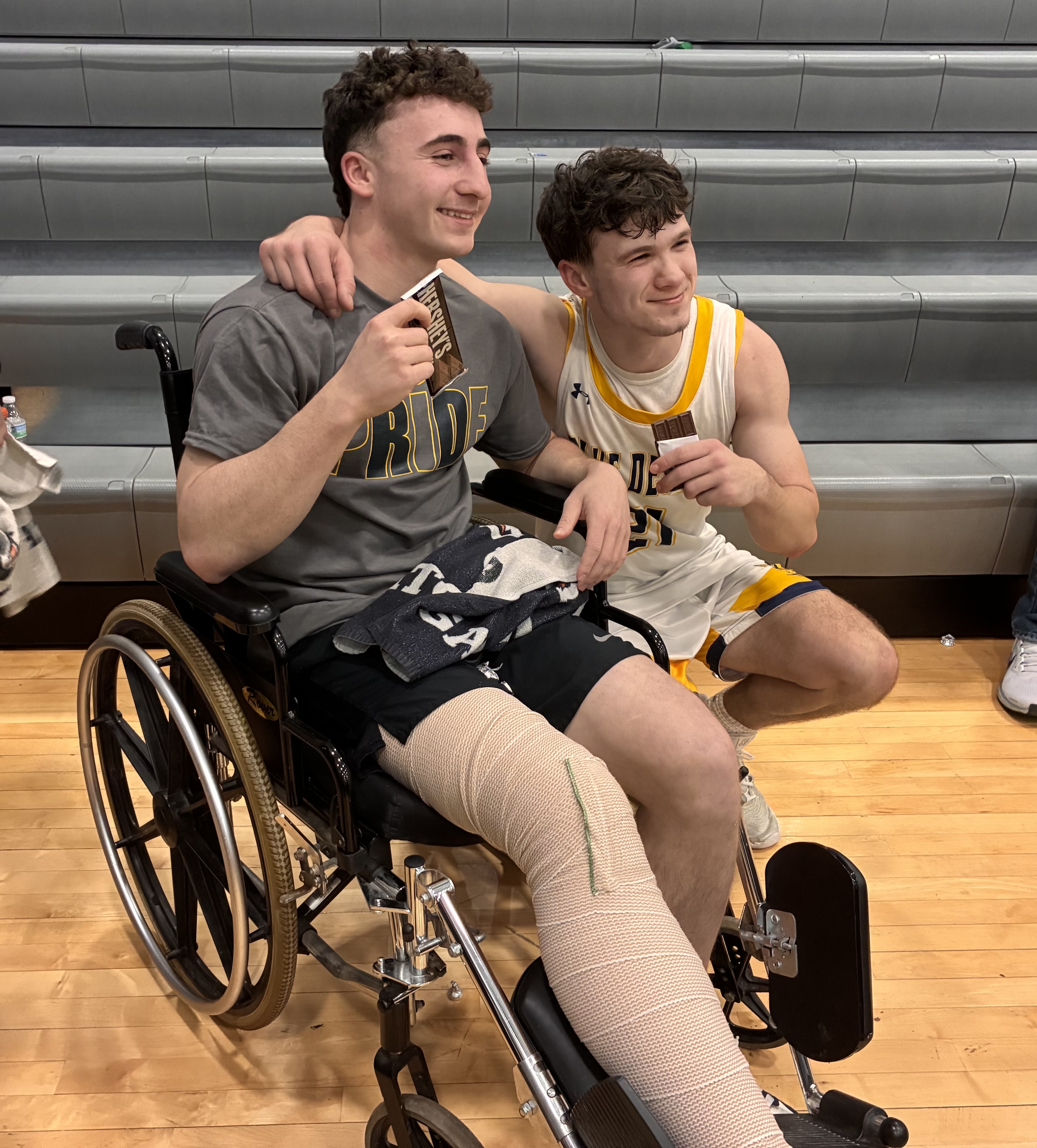 Nick Salerno, right, with injured teammate Ryan DeMarco after Old...