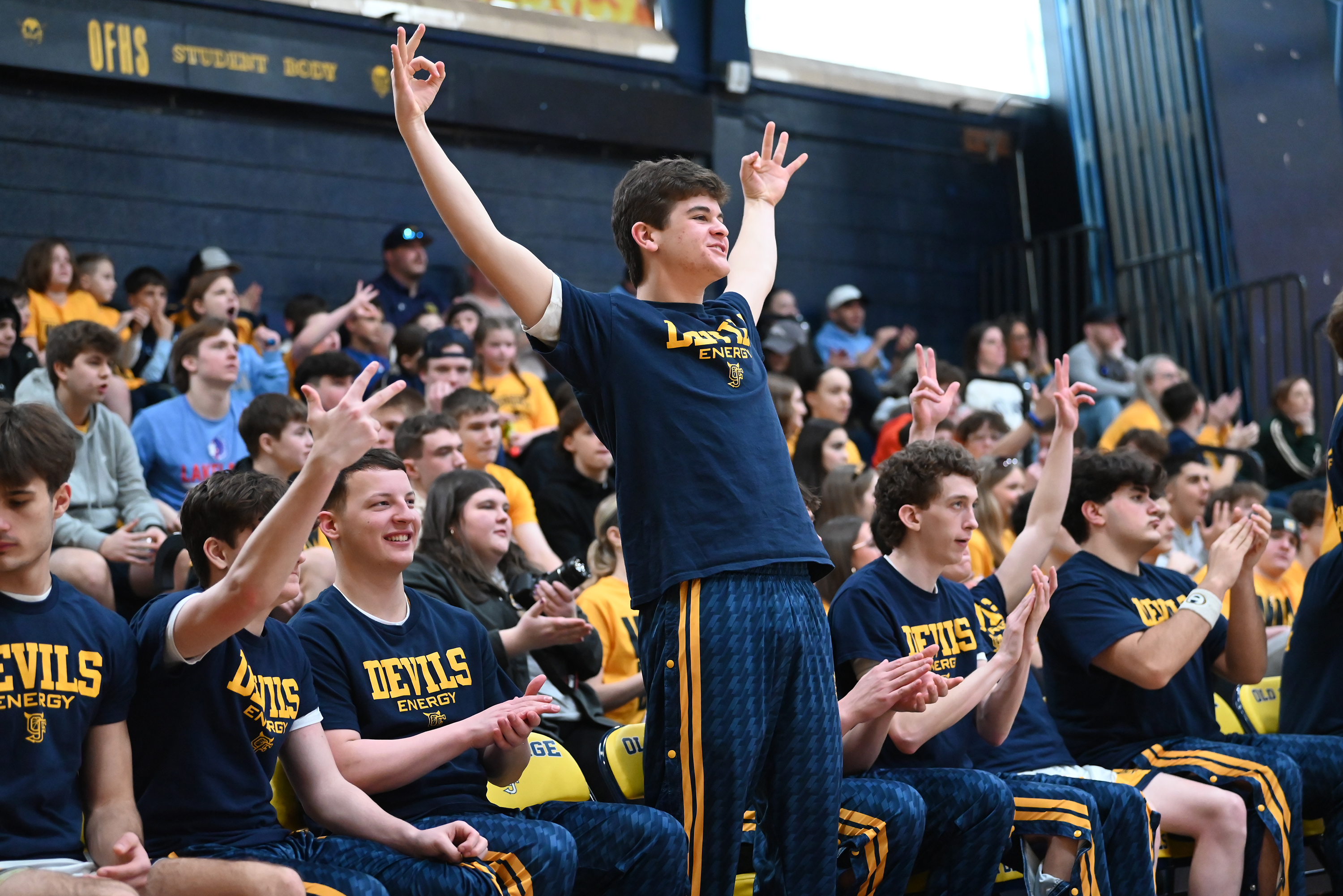 The Blue Devils’ bench cheers as their team scores against...