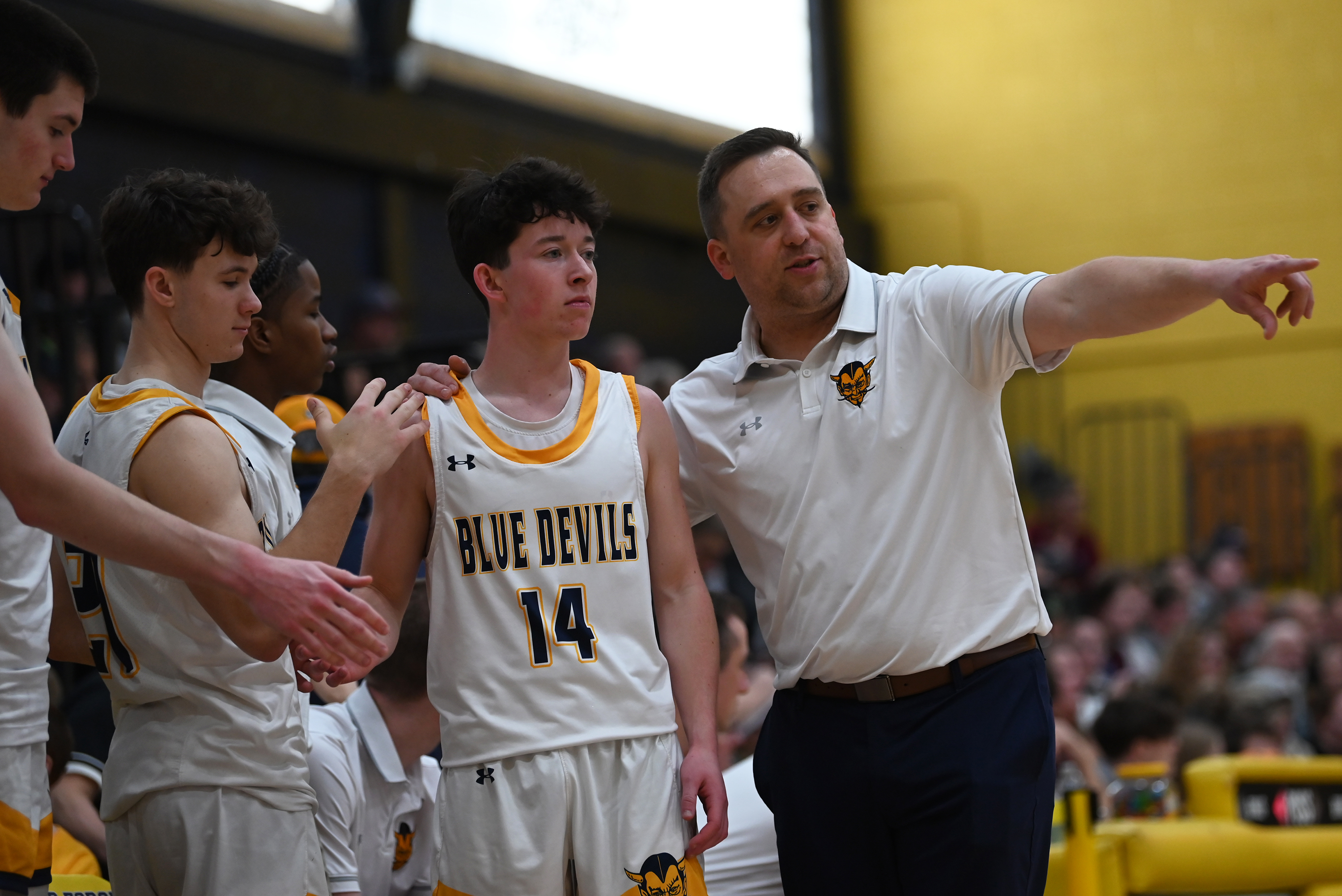 Old Forge’s head coach JJ Thomas talks to player Ayden...