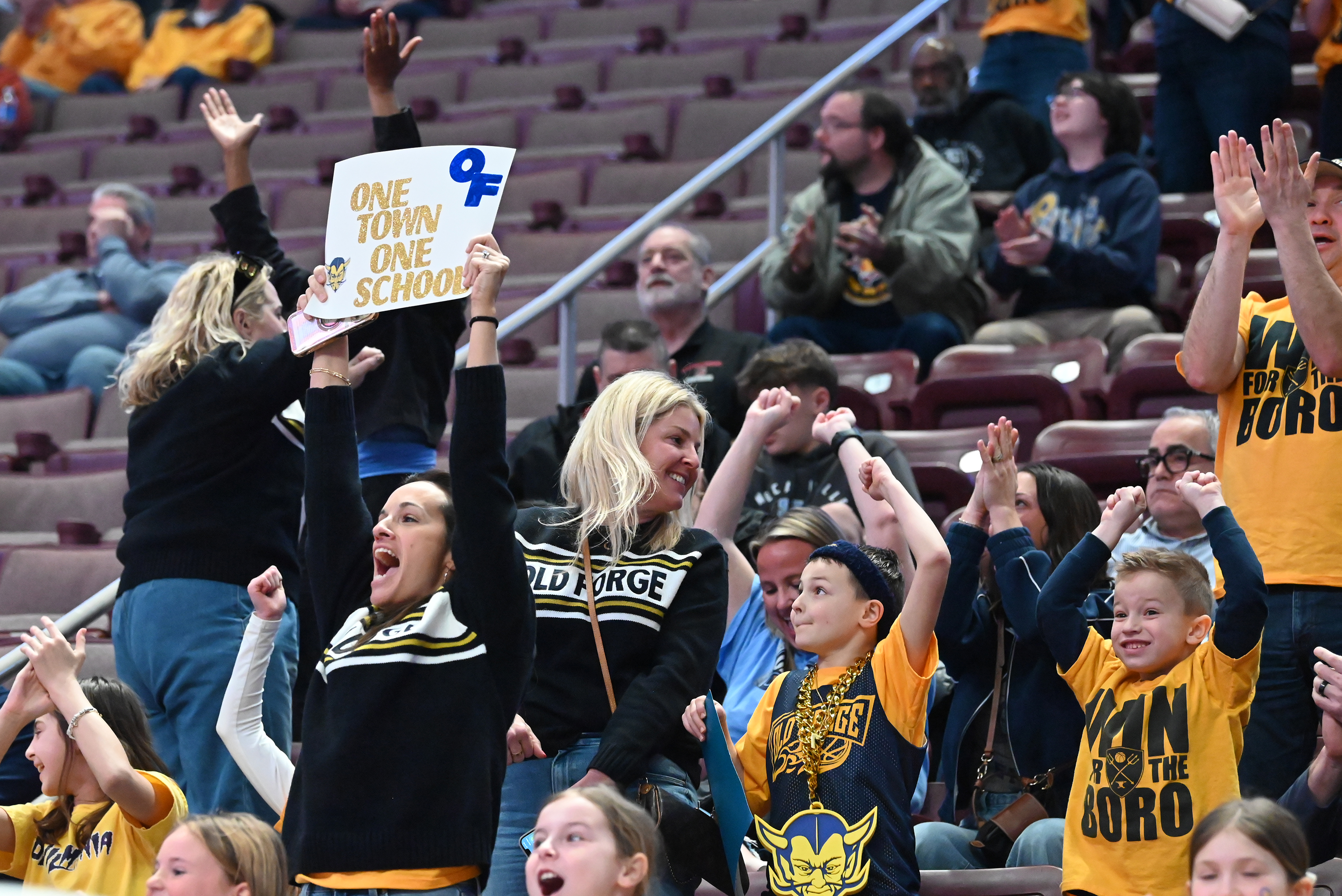 Old Forge fans cheer as their team scores during the...